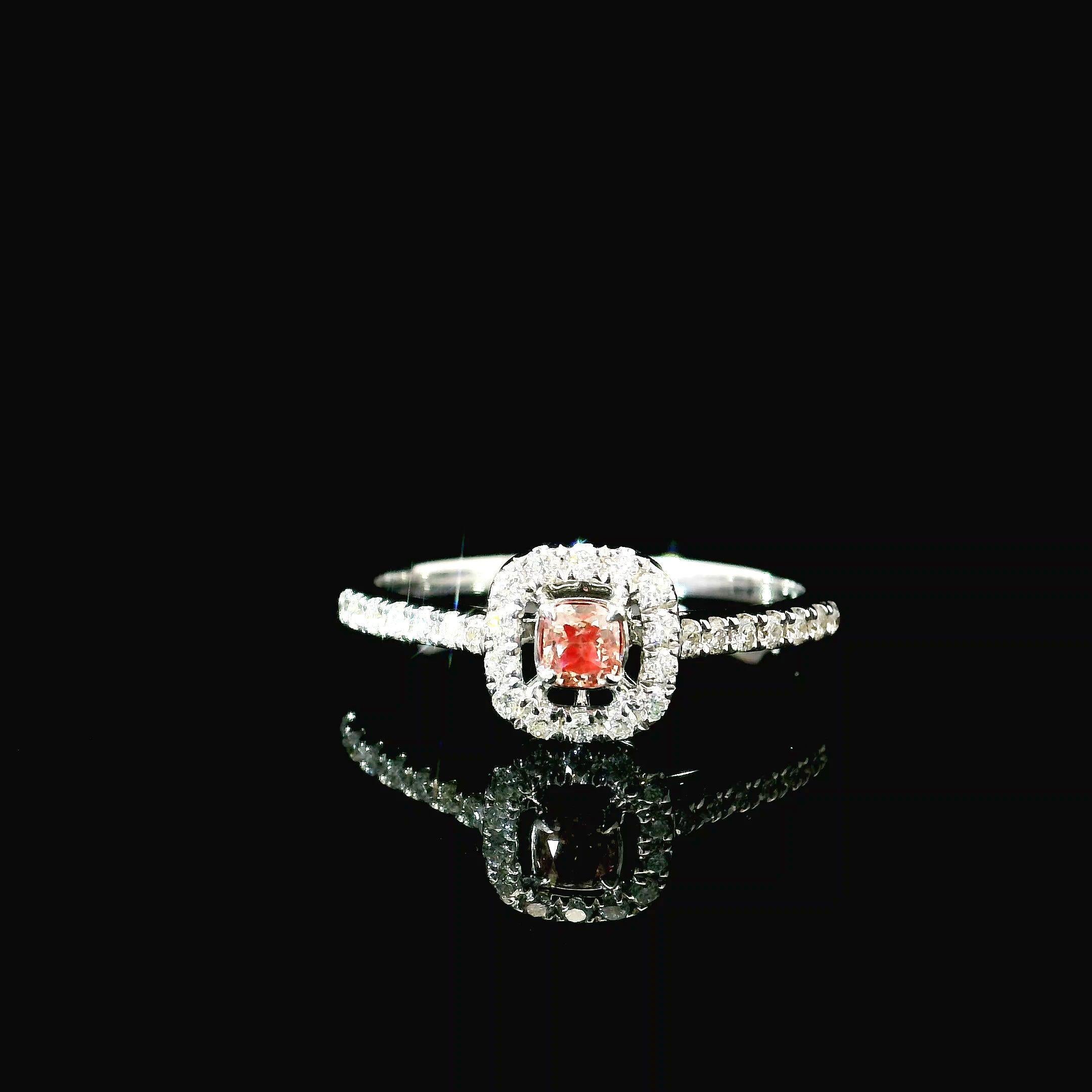18kt white gold ring with diamonds
  
  Gold colour & karat: White gold 18kt
  Weight: 1.97 grams
  
  Set with-
  Stone type: Diamonds
  Shape: Cushion
  Carat: 0.127 ct
  Colour: Fancy Intense Pink
  Clarity: VS
  
  Surrounding Stones: Diamonds
