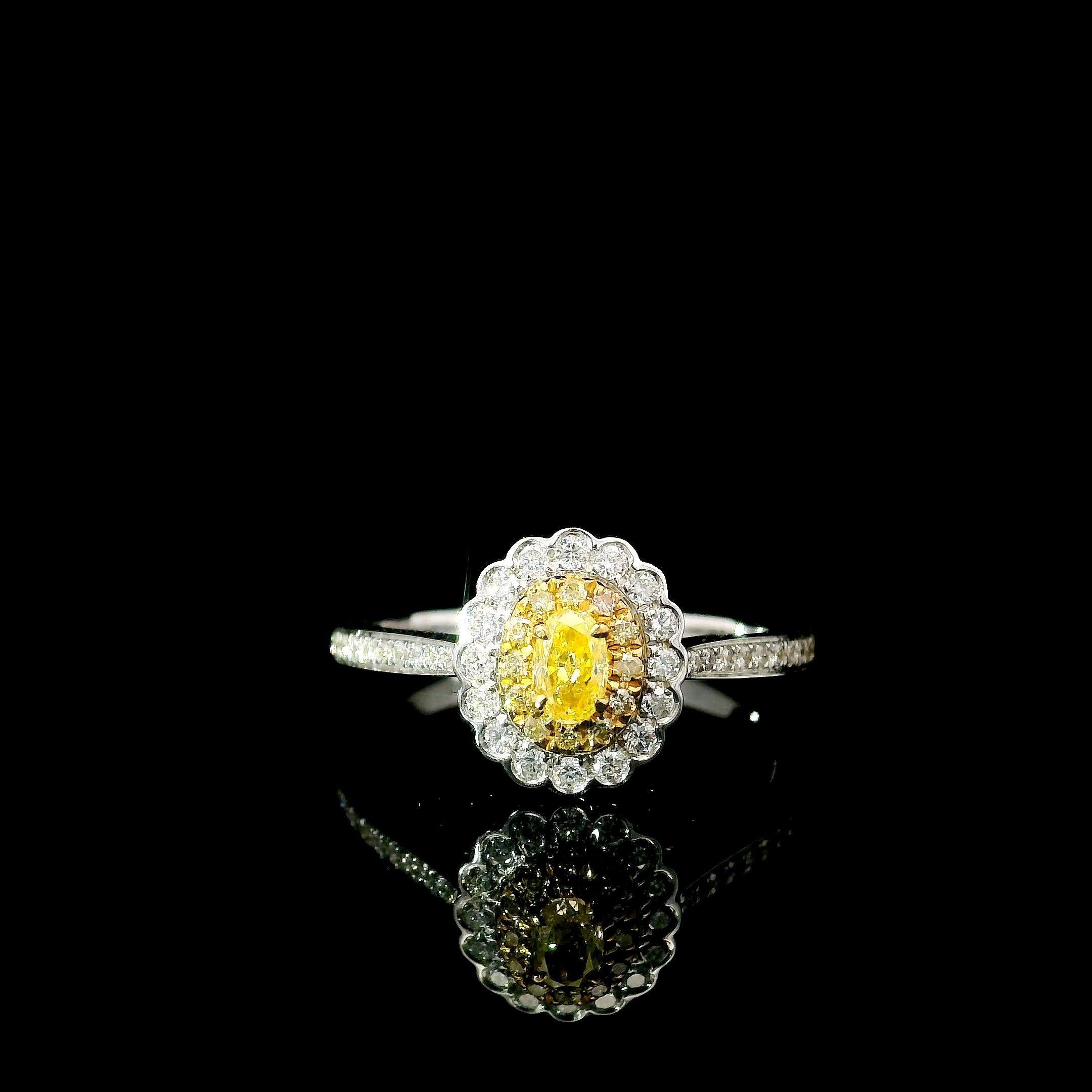 18kt white gold ring with diamonds
  
  Gold colour & karat: White gold 18kt
  Weight: 2.37 grams
  
  Set with-
  Stone type: Diamonds
  Shape: Oval
  Carat: 0.137 ct
  Colour: Fancy Yellow
  Clarity: SI
  
  Surrounding Stones: Diamonds
 1) White