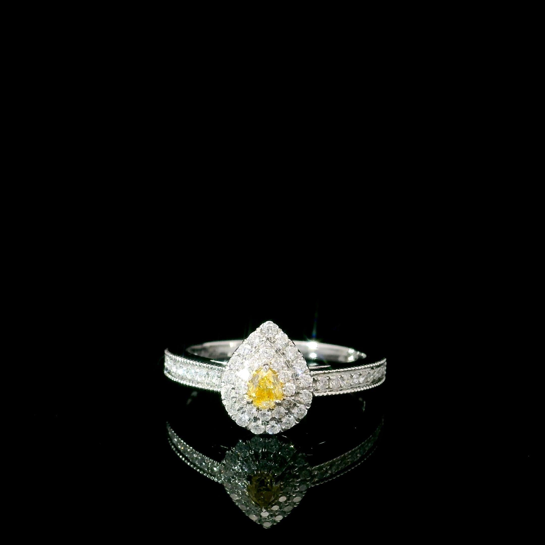 18kt white gold ring with diamonds
  
  Gold colour & karat: White gold 18kt
  Weight: 2.85 grams
  
  Set with-
  Stone type: Diamonds
  Shape: Pear
  Carat: 0.147 ct
  Colour: Fancy Intense Yellow
  Clarity: VS
  
  Surrounding Stones: Diamonds

