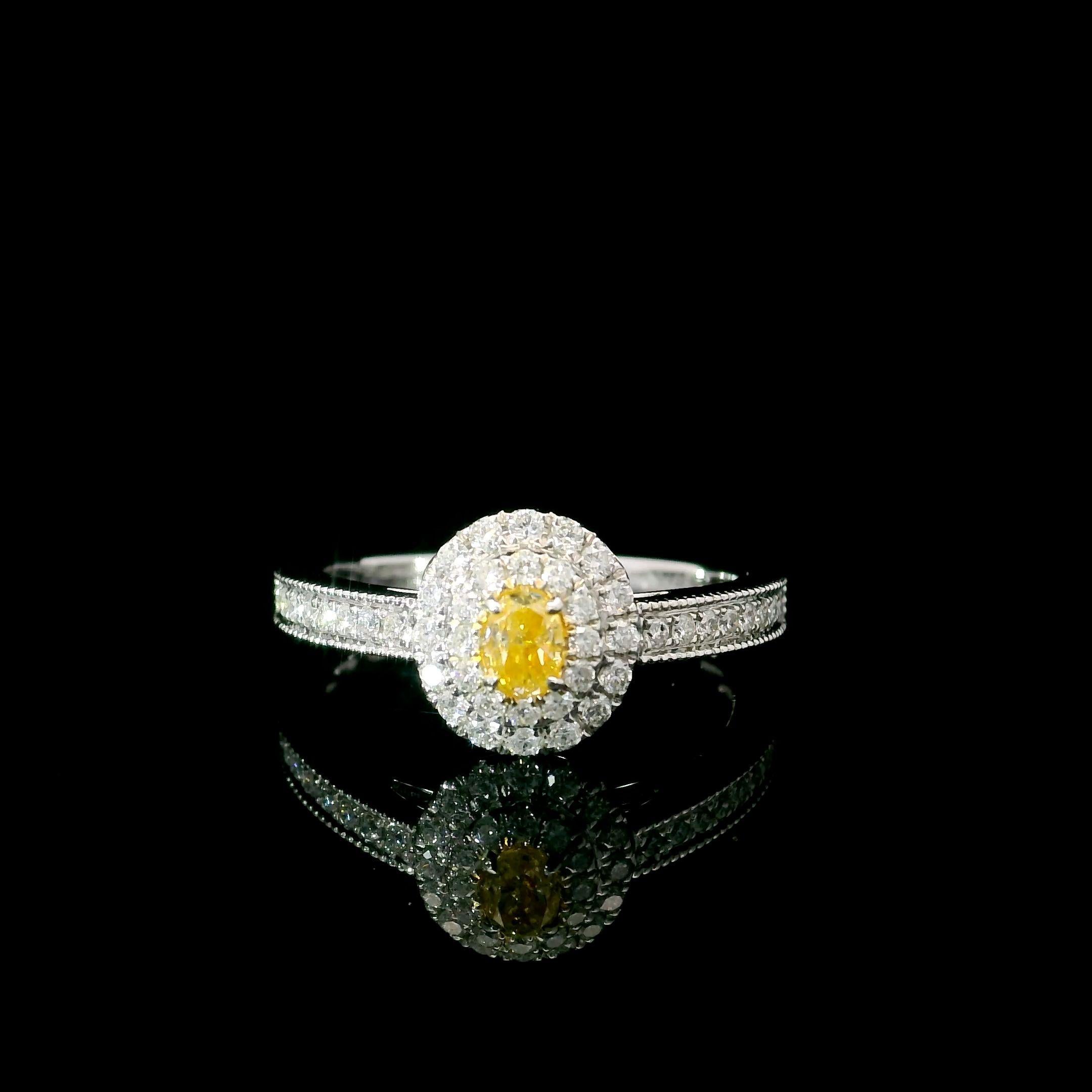 18kt white gold ring with diamonds
  
  Gold colour & karat: White gold 18kt
  Weight:  2.65 grams
  
  Set with-
  Stone type: Diamonds
  Shape: Oval
  Carat:  0.186 ct
  Colour: Fancy Intense Yellow
  Clarity: VS
  
  Surrounding Stones: Diamonds
