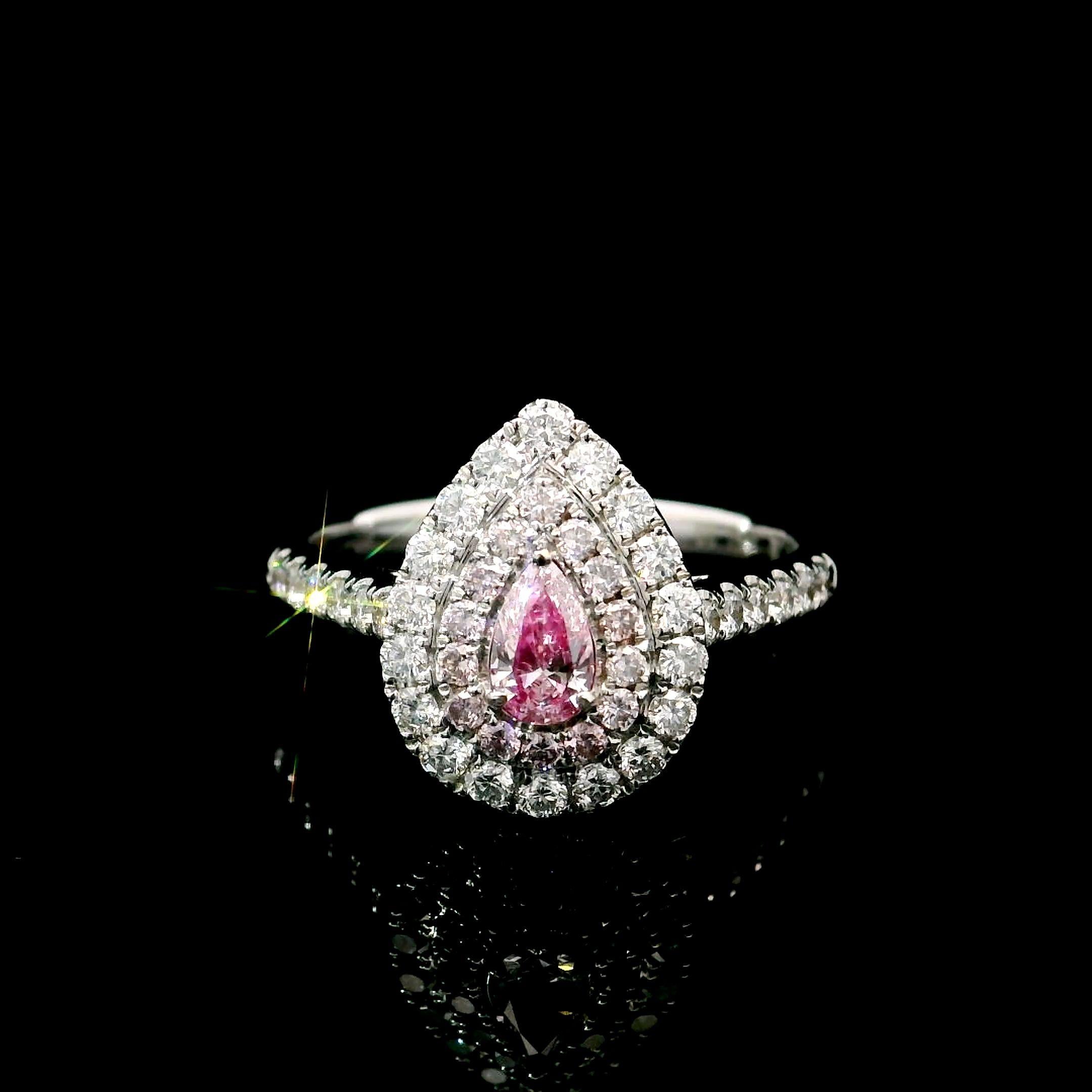 18kt white gold ring with diamonds
  
  Gold colour & karat: White gold 18kt
  Weight: 3.917 grams
  
  Set with-
  Stone type: Diamonds
  Shape: Pear
  Carat: 0.19 ct
  Colour: Fancy Pink
  Clarity: VS
  
  Surrounding Stones: Diamonds
 1) White