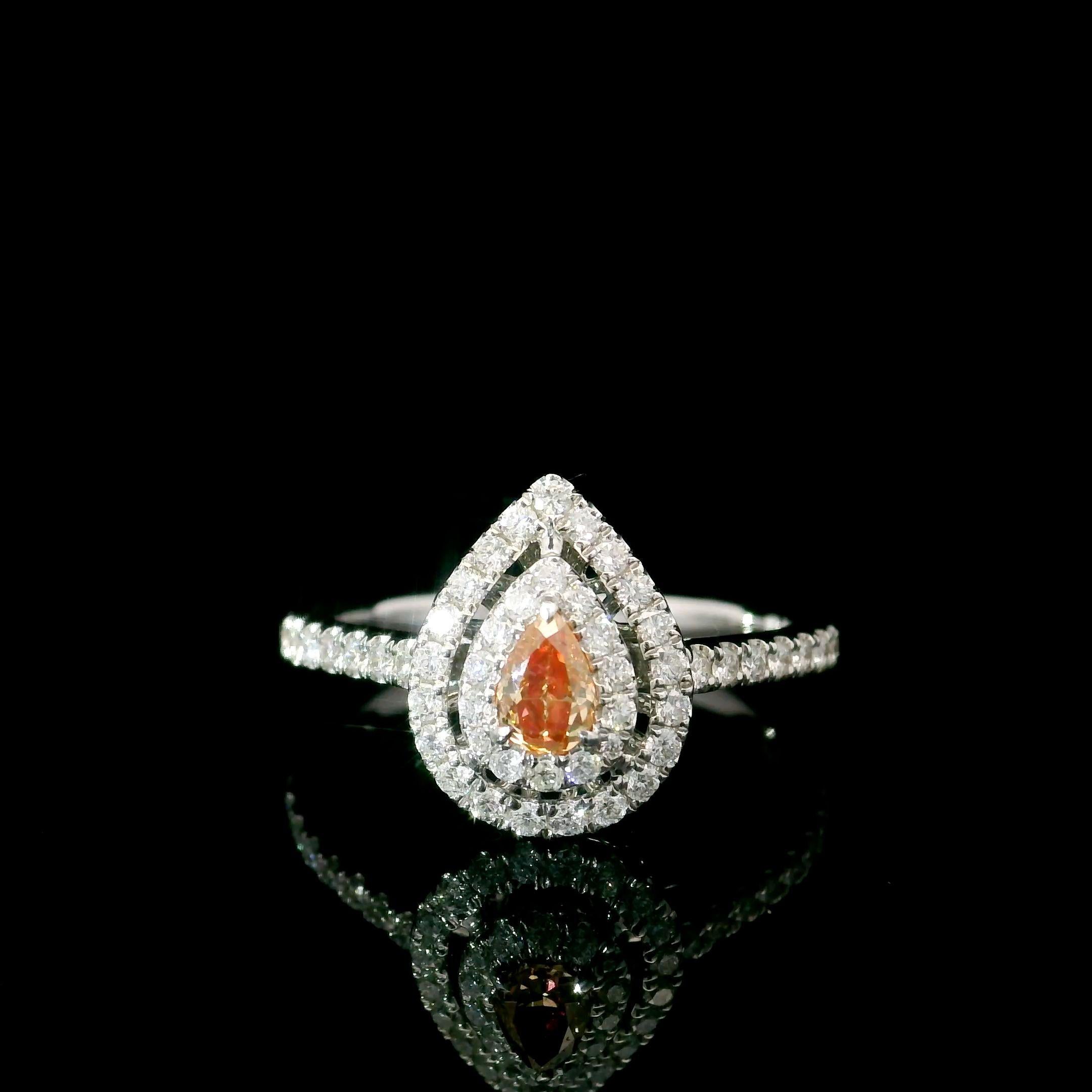 18kt white gold ring with diamonds
  
  Gold colour & karat: White gold 18kt
  Weight: 2.9 grams
  
  Set with-
  Stone type: Diamonds
  Shape: Pear
  Carat: 0.203 ct
  Colour: Fancy Pink
  Clarity: VS
  
  Surrounding Stones: Diamonds
 1) White