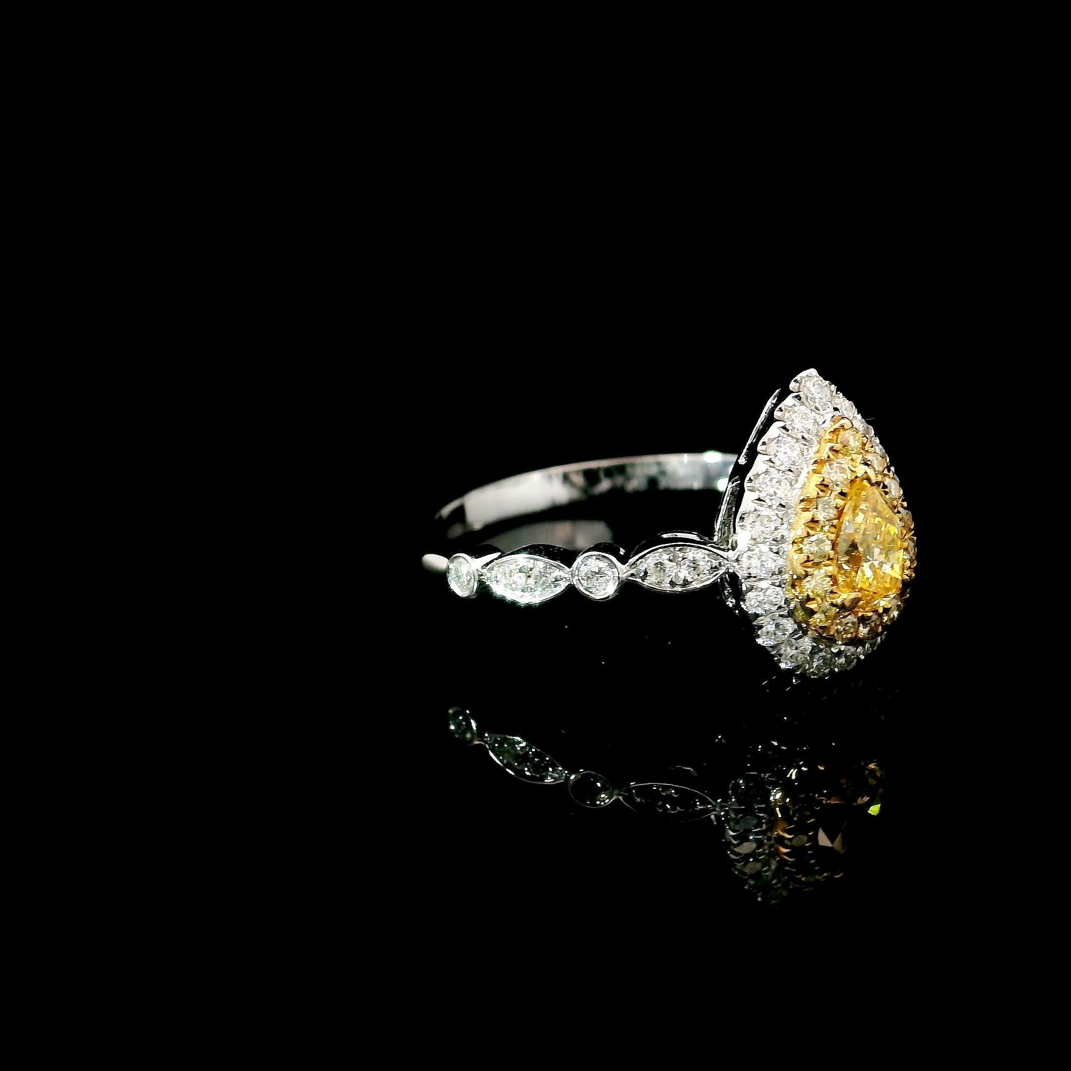  18kt white gold ring with diamonds
  
  Gold colour & karat: White gold 18kt
  Weight: 2.52 grams
  
  Set with-
  Stone type: Diamonds
  Shape: Pear
  Carat: 0.233 ct
  Colour: Fancy Intense Yellow
  Clarity: VS
  
  Surrounding Stones: Diamonds
