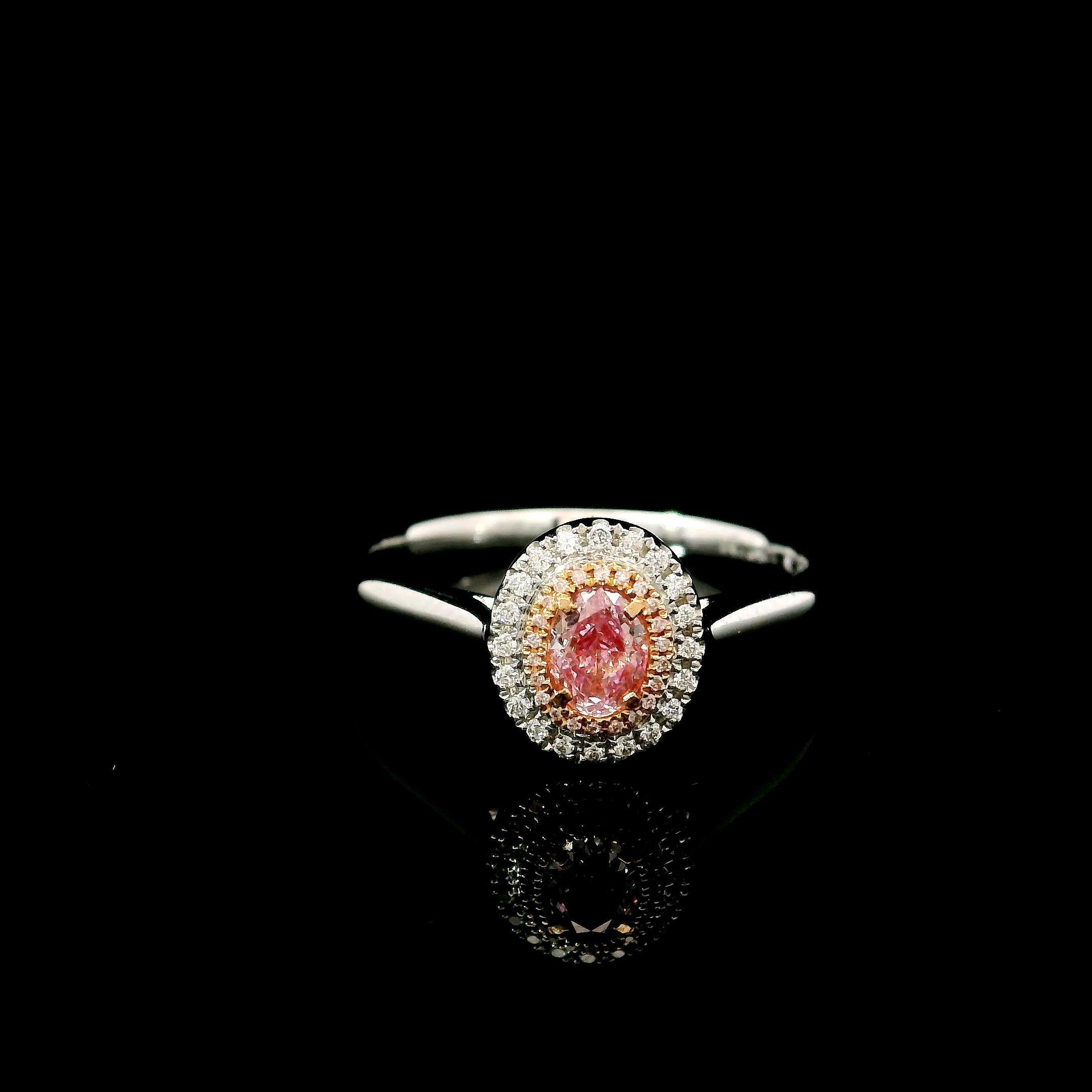 18kt white gold ring with diamonds
  
  Gold colour & karat: White gold 18kt
  Weight: 2.624 grams
  
  Set with-
  Stone type: Diamonds
  Shape: Oval
  Carat: 0.24 ct
  Colour: Fancy Pink
  Clarity: VS
  
  Surrounding Stones: Diamonds
 1) White