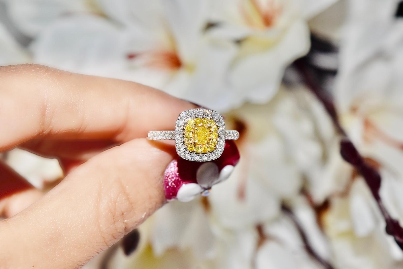 18kt white gold ring with diamonds
  
  Gold colour & karat: White gold 18kt
  Weight: 3.510 grams
  
  Set with-
  Stone type: Diamonds
  Shape: Cushion
  Carat: 0.24 ct
  Colour: Fancy Yellow
  Clarity: VS
  
  Surrounding Stones: Diamonds
 1)