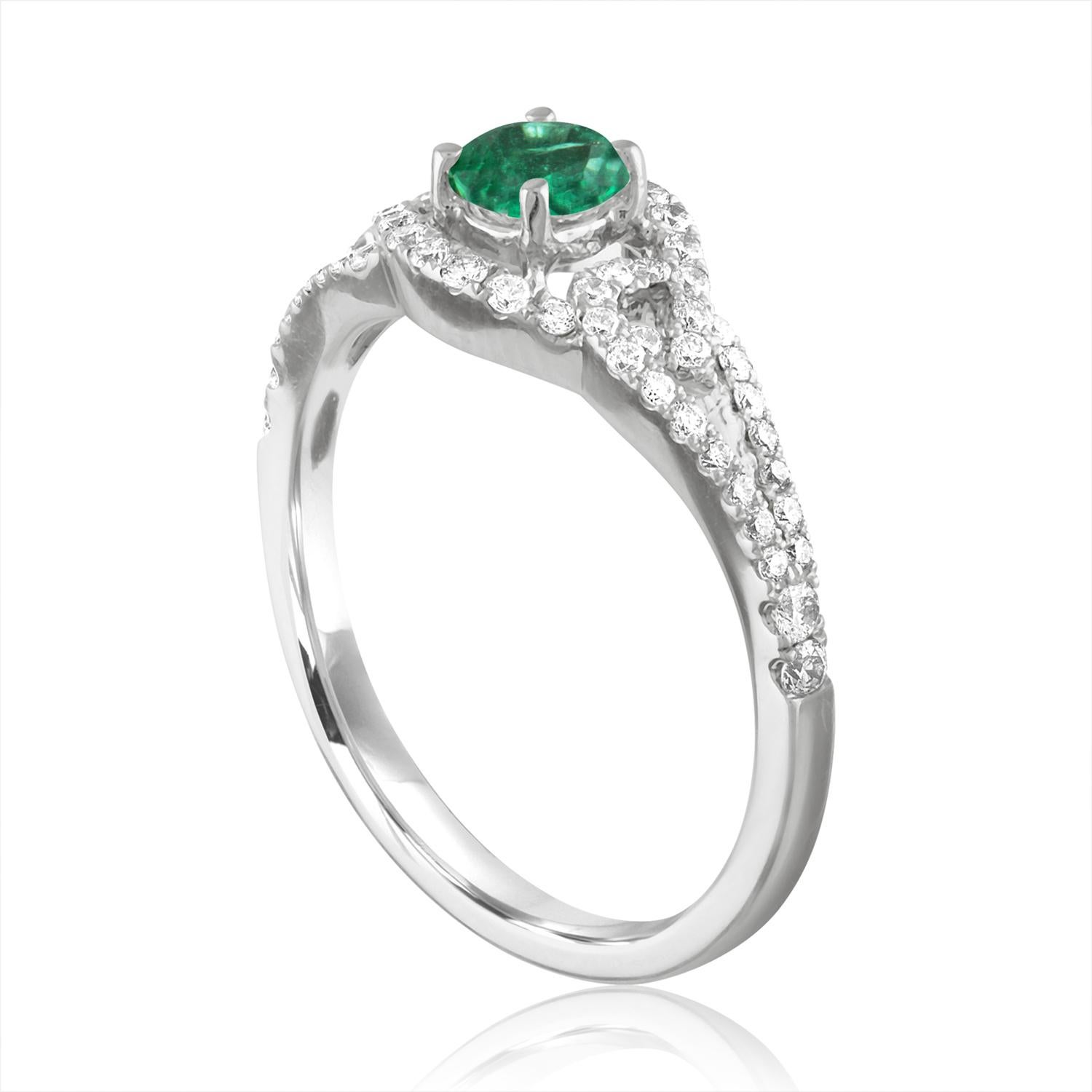 Beautiful Round Halo Criss Cross Shank Emerald Ring
The ring is 18K White Gold.
The Center is a beautiful Round cut 0.28 Carat Emerald.
The Emerald is AGL certified.
There are 0.45 Carats in Diamonds F/G VS/SI
The ring is a size 6.50, sizable.
The