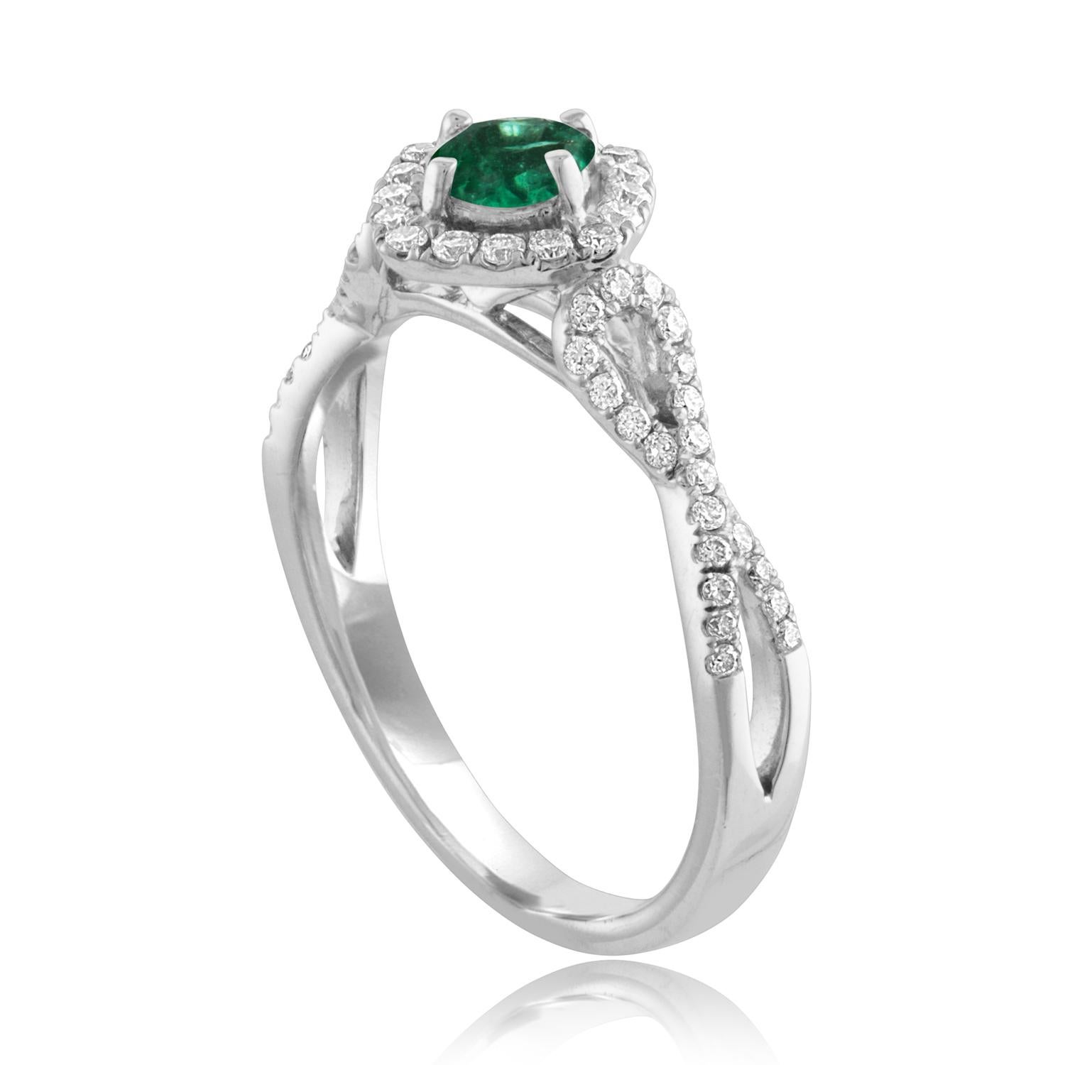 Beautiful Square Halo Criss Cross Shank Emerald Ring
The ring is 18K White Gold.
The Center is a beautiful Round cut 0.29 Carat Emerald.
The Emerald is AGL certified.
There are 0.45 Carats in Diamonds F/G VS/SI
The ring is a size 6.50, sizable.
The