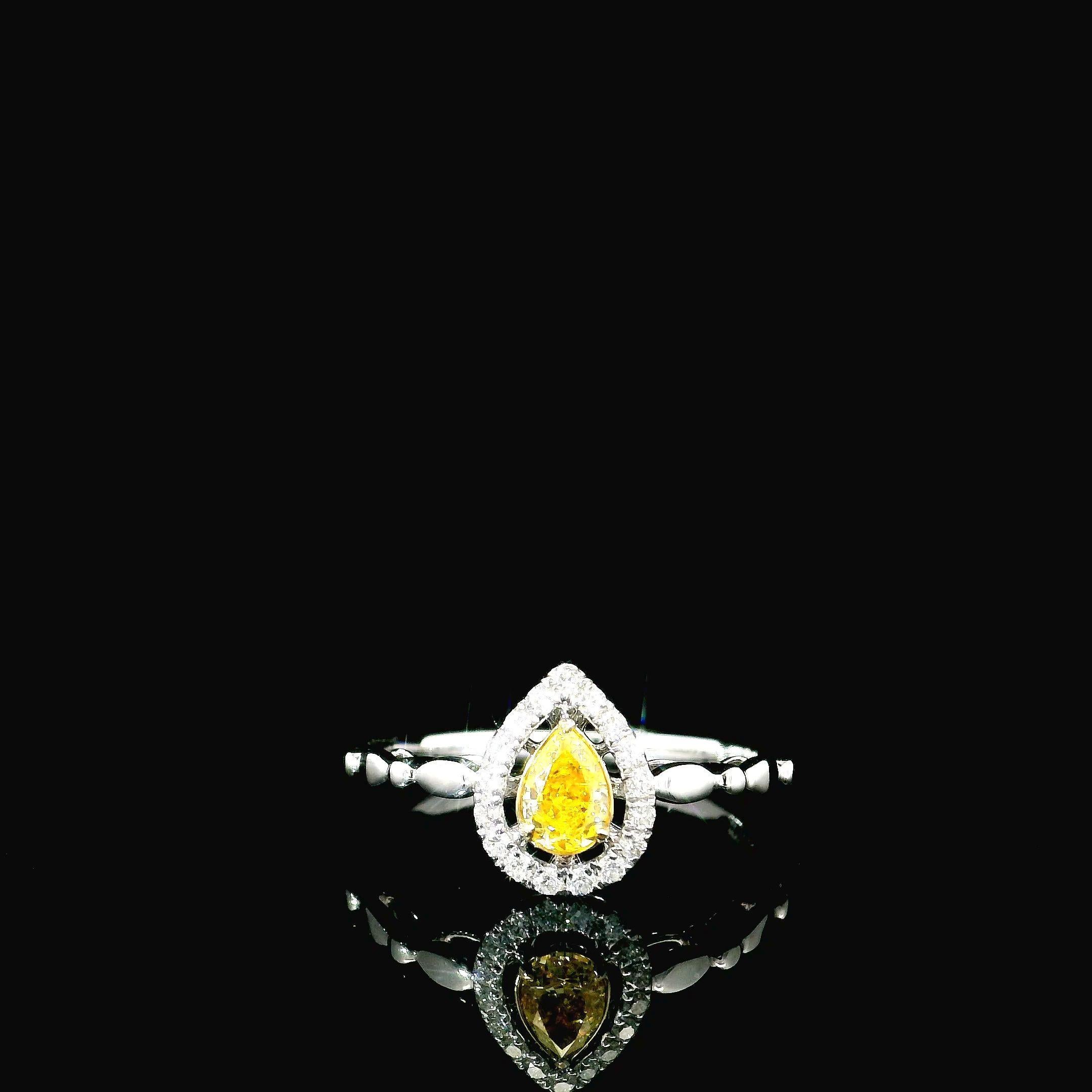 18kt white gold ring with diamonds
  
  Gold colour & karat: White gold 18kt
  Weight: 1.84 grams
  
  Set with-
  Stone type: Diamonds
  Shape: Pear
  Carat: 0.324 ct
  Colour: Fancy Vivid Yellow
  Clarity: VS
  
  Surrounding Stones: Diamonds
 1)