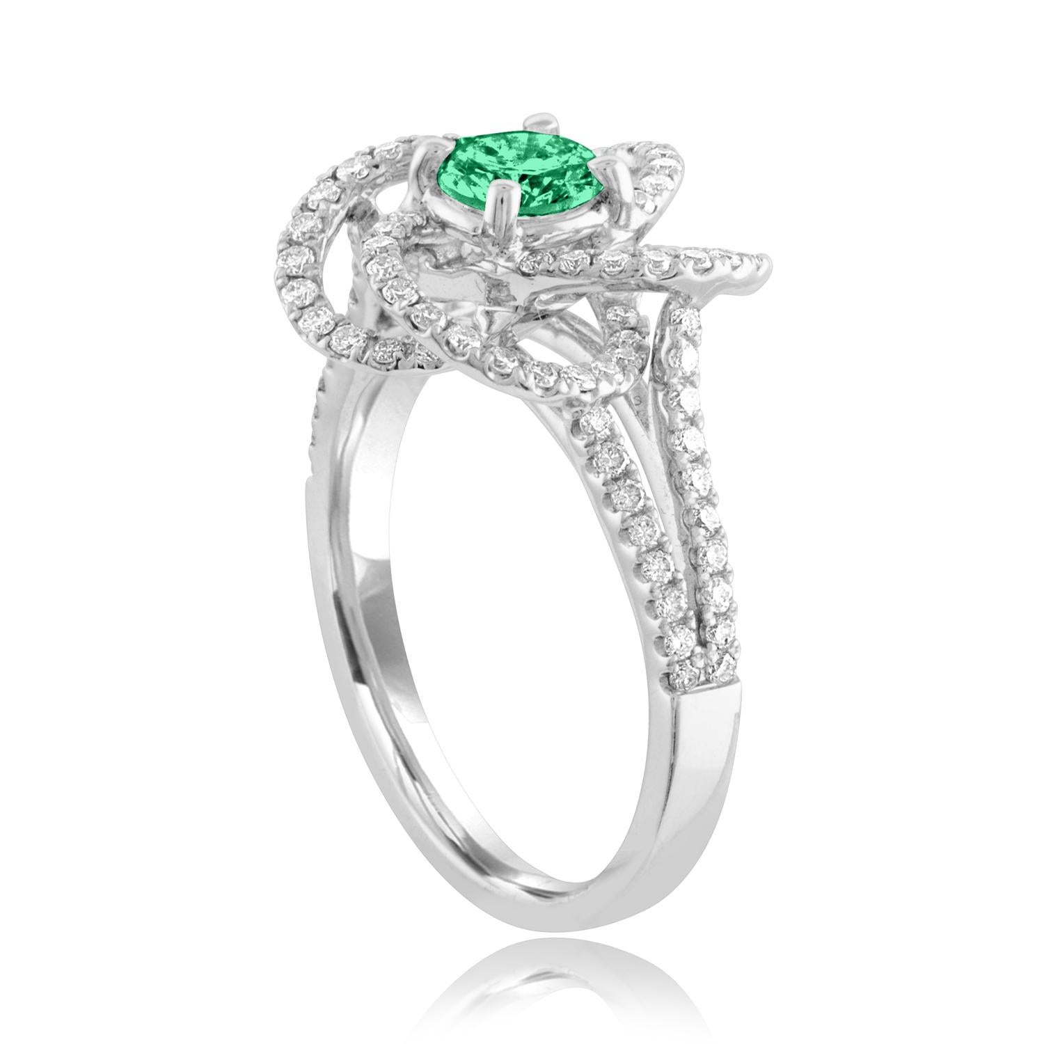 Magnifique bague à fleur de diamant et d'émeraude
La bague est en or blanc 18 carats.
Il y a 0.92 carats de diamants F/G VS/SI.
Le centre est une émeraude ronde de 0,35 carat.
L'Emerald est certifié par l'AGL.
L'anneau est une taille 6.50, de bonne