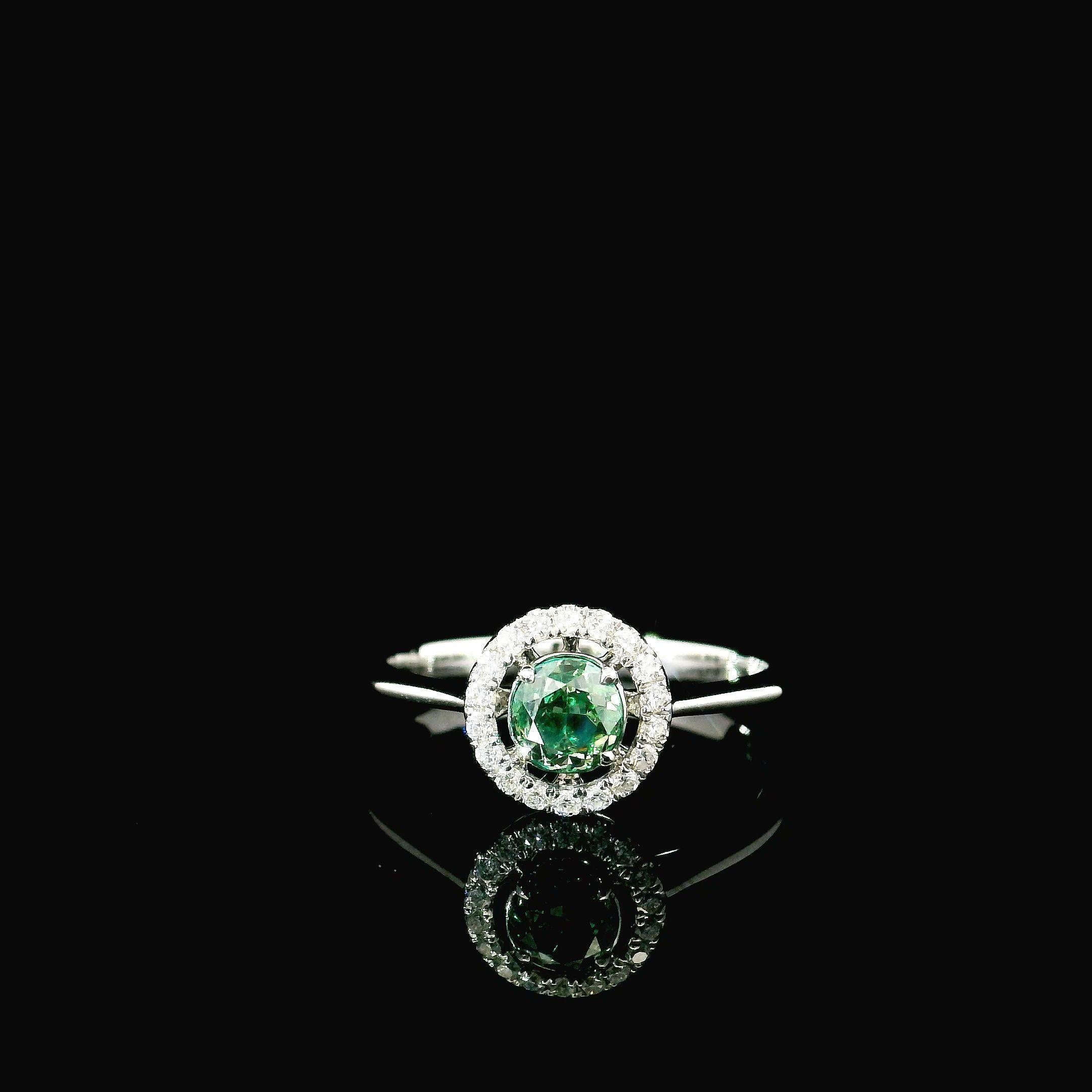 18kt white gold ring with diamonds
  
  Gold colour & karat: White gold 18kt
  Weight: 2.20 grams
  
  Set with-
  Stone type: Diamonds
  Shape: Oval
  Carat: 0.505 ct
  Colour: Fancy Intense Green
  Clarity: VVS
  
  Surrounding Stones: Diamonds
