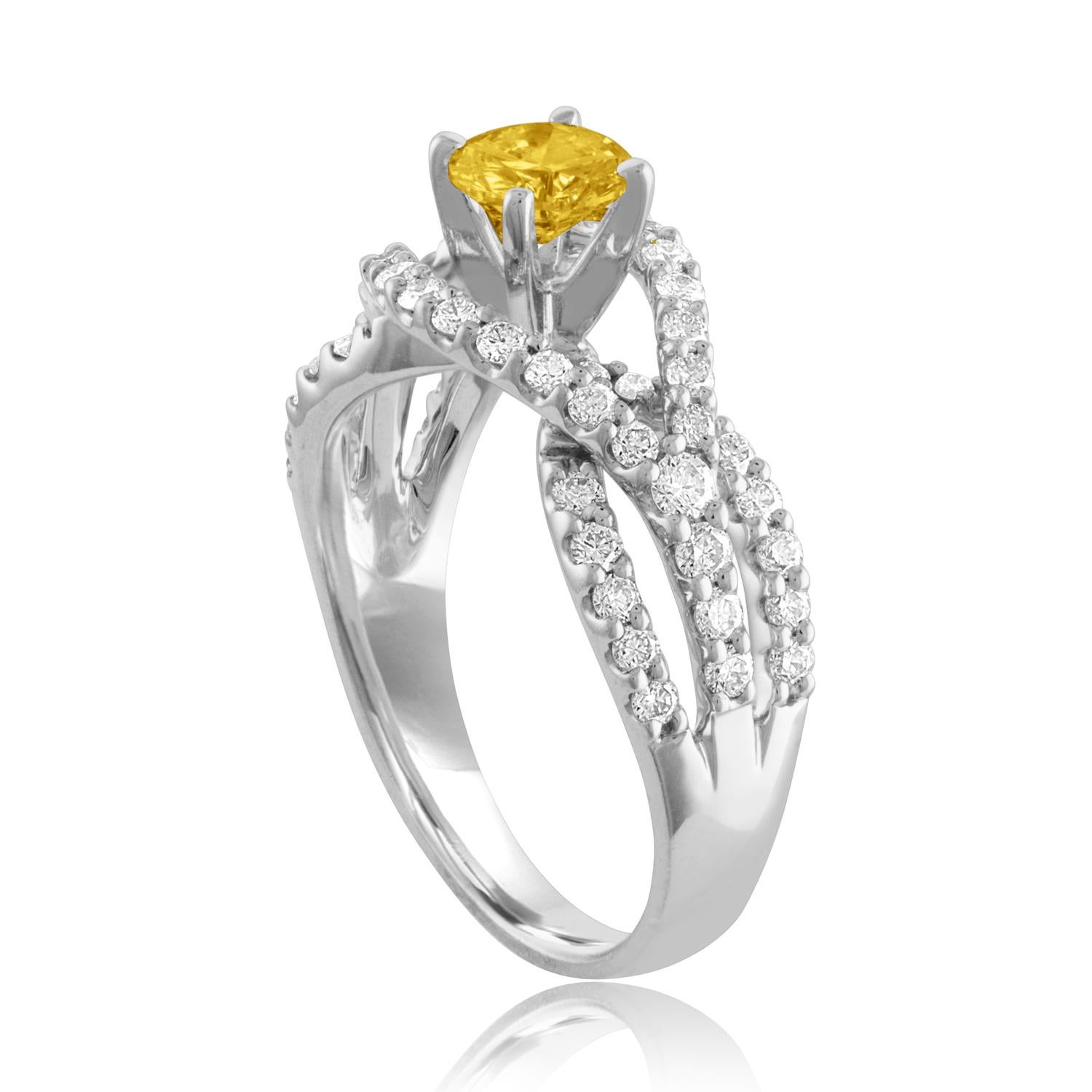 Beautiful Twist Shank Ring
The ring is 18K White Gold
The Center Stone is a Round Yellow Sapphire 0.59 Carats
The Sapphire is AGL Certified Heated
There are 0.78 Carats in Diamonds F/G VS/SI
The ring is a size 6.75, sizable.
The ring weighs 5.1 grams