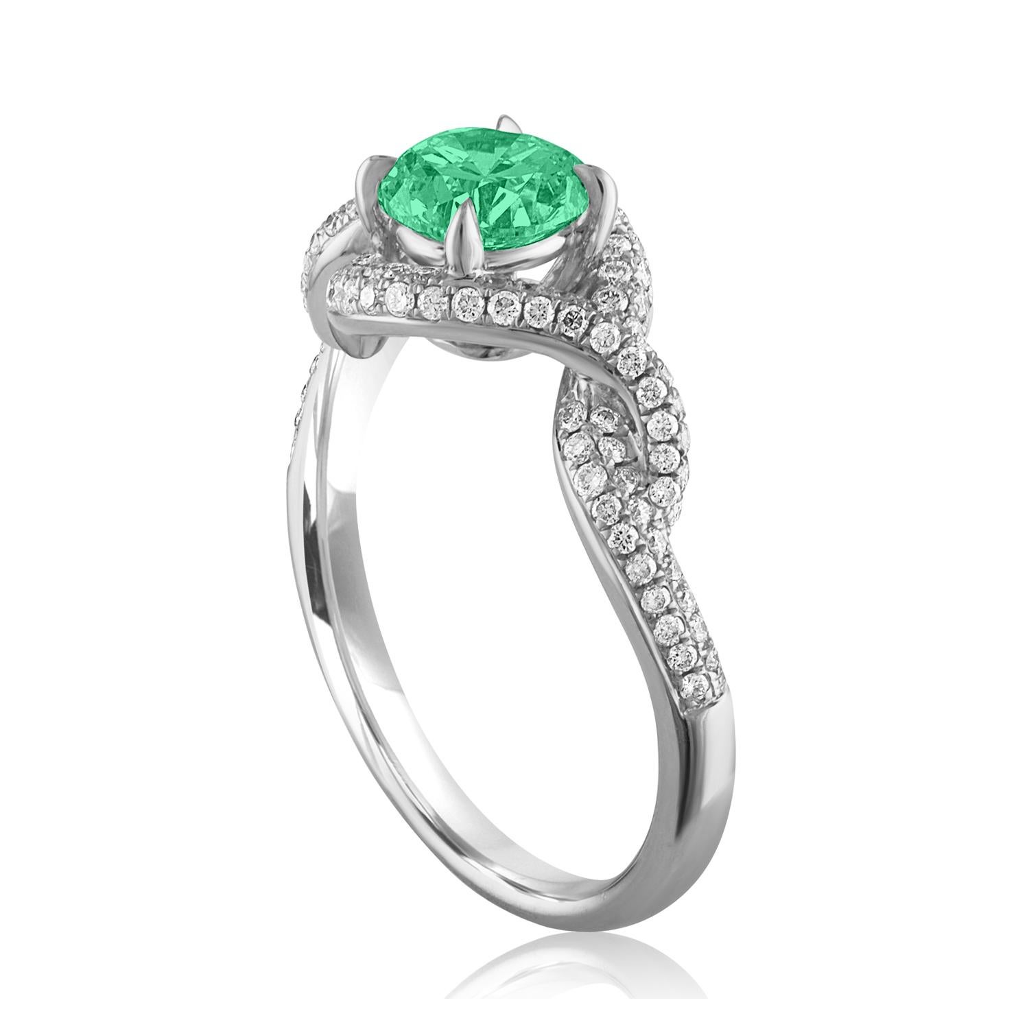Beautiful Twist Shank Emerald Ring
The ring is 18K White Gold.
There are 0.40 Carats in Diamonds F/G VS/SI
The Center is Round 0.67 Carat Emerald.
The Emerald is AGL certified.
The ring is a size 6.75, sizable.
The ring weighs 3.8 grams.