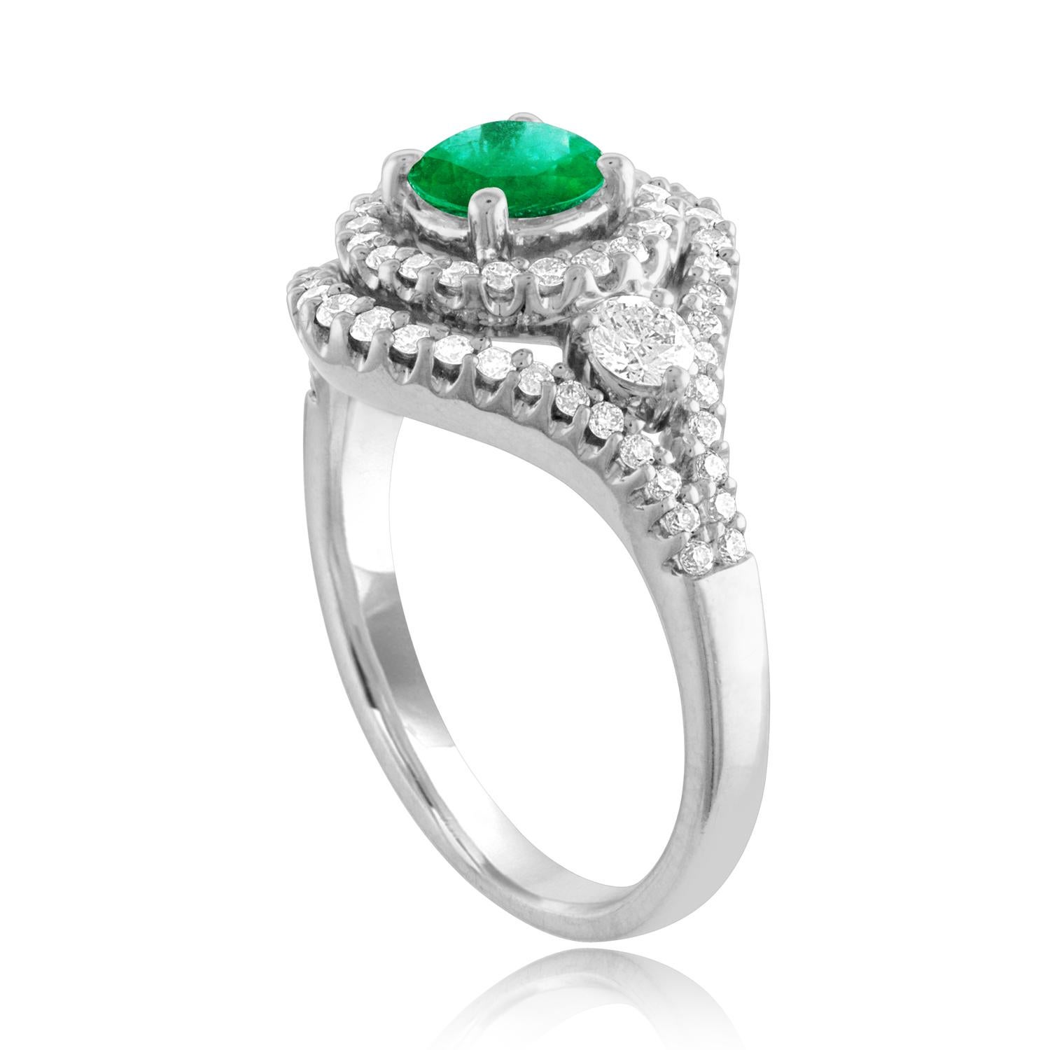 Beautiful Double Halo Emerald Ring
The ring is 18K White Gold.
The Center is a beautiful round cut 0.78 Carat Emerald.
The Emerald is AGL certified.
There are 1.07 Carats in Diamonds F/G VS/SI
The ring is a size 7.00, sizable.
The ring weighs 6.8