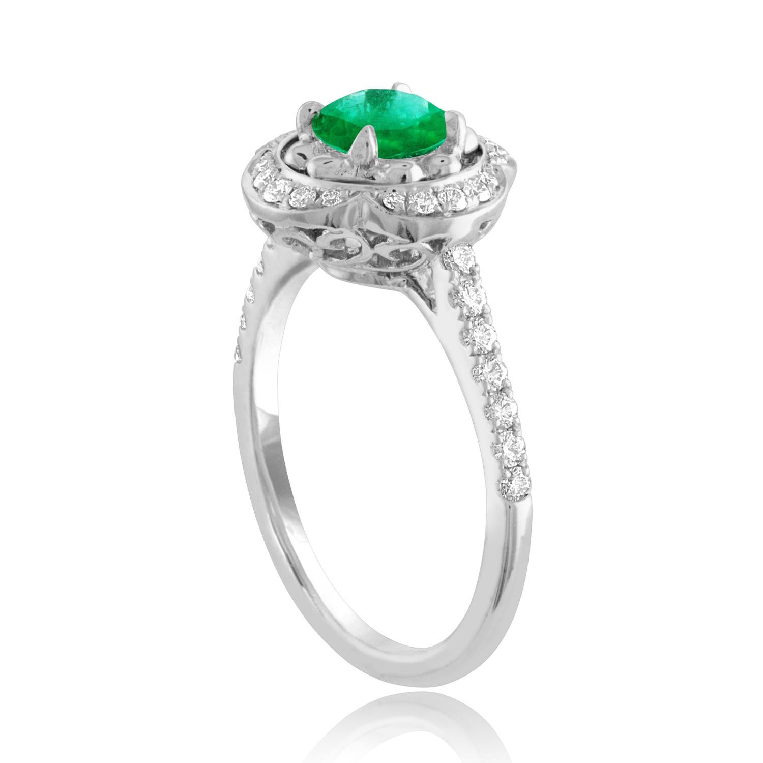 Beautiful Halo Flower Emerald Ring
The ring is 18K White Gold.
The Center is a beautiful round cut 0.87 Carat Emerald.
The Emerald is AGL certified.
There are 0.32 Carats in Diamonds F/G VS/SI
The ring is a size 6.50, sizable.
The ring weighs 4.0