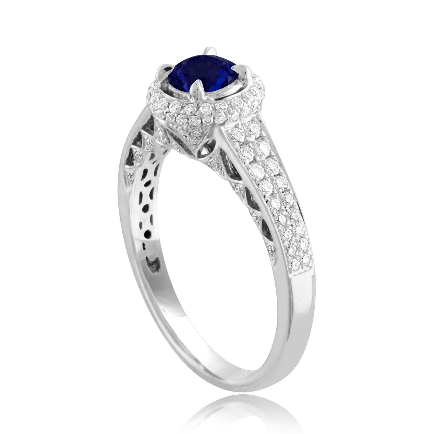 Beautiful Round Halo Pave Ring
The ring is 18K White Gold
The Center Stone is a Round Blue Sapphire 0.91 Carats
The Sapphire is AGL Certified Heated
There are 0.49 Carats in Diamonds F/G VS/SI
The ring is a size 7.00, sizable.
The ring weighs 3.9