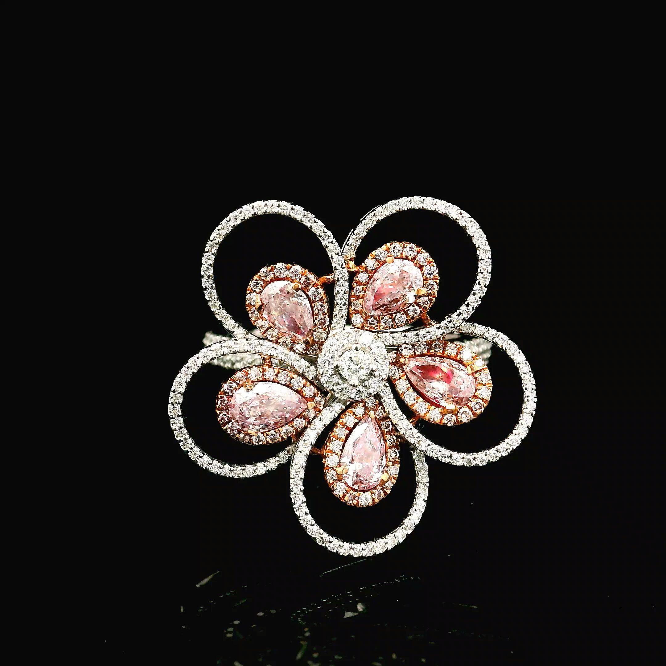 18 kt white gold ring with diamonds
  
  Gold colour & Carat: White gold 18kt
  Weight: 6.430 grams
  
  Set with-
  Stone type: Diamonds
  Shape: Pear
  Carat: 0.950 ct
  Colour: Fancy Pink
  Clarity: VS
  
  Surrounding Stones: Diamonds
 1) White