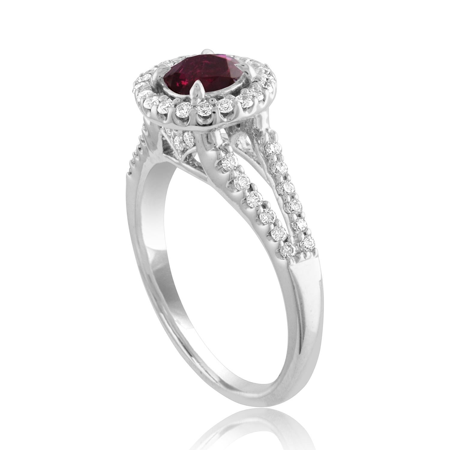 Beautiful Round Halo Split Shank Ring
The ring is 18K White Gold
The Center Stone is a Round Ruby 1.00 Carats
The Ruby is AGL Certified Heated
There are 0.33 Carats in Diamonds F/G VS/SI
The ring is a size 6.5, sizable.
The ring weighs 4.4 grams