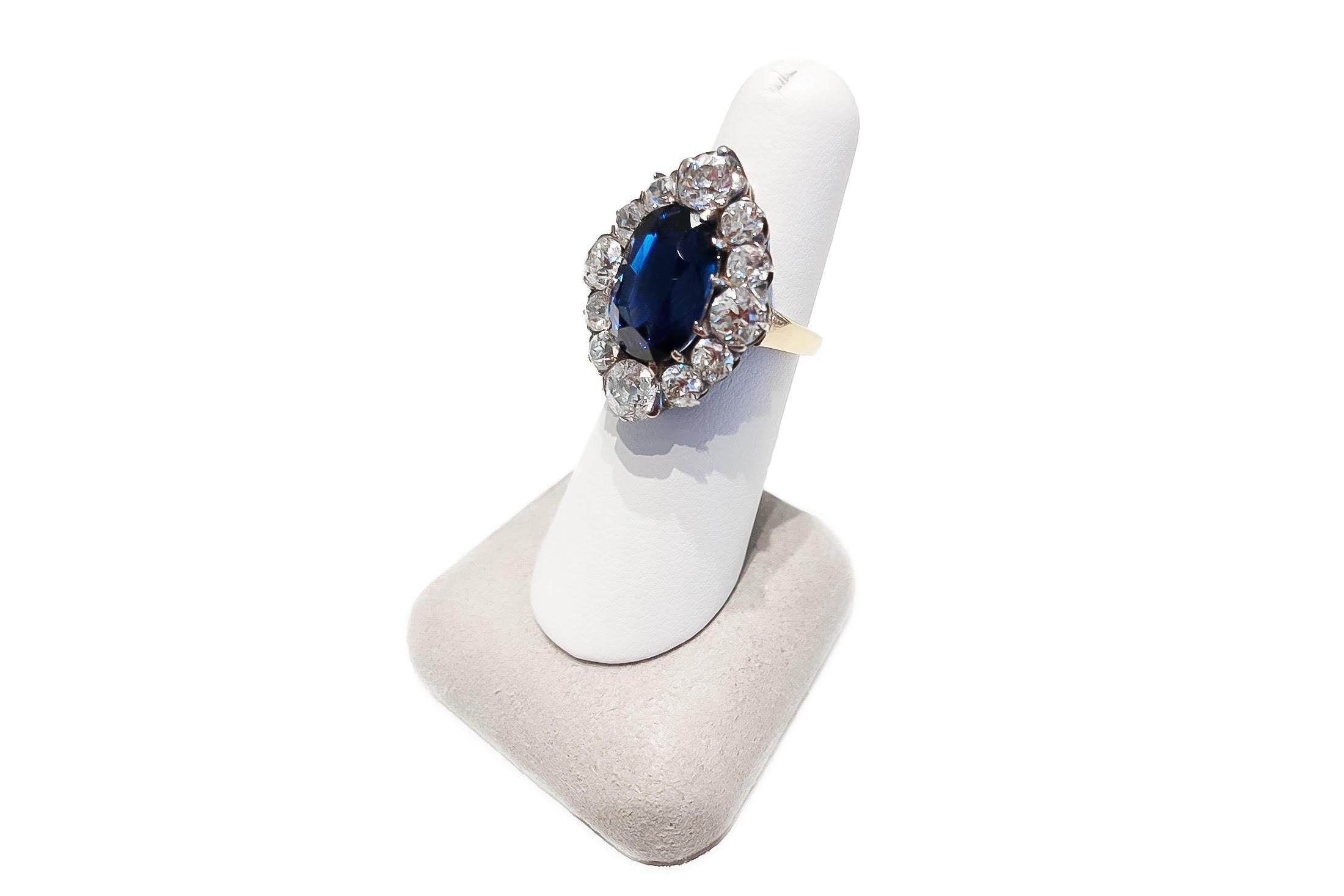 Oval Cut Blue Sapphire weighing 10.04 carats, set in 18K Yellow and White Gold Ring accented with twelve round old-cut diamonds. Sapphire is from Sri Lanka, Ceylon, no Heat.
AGL# CS1073487 