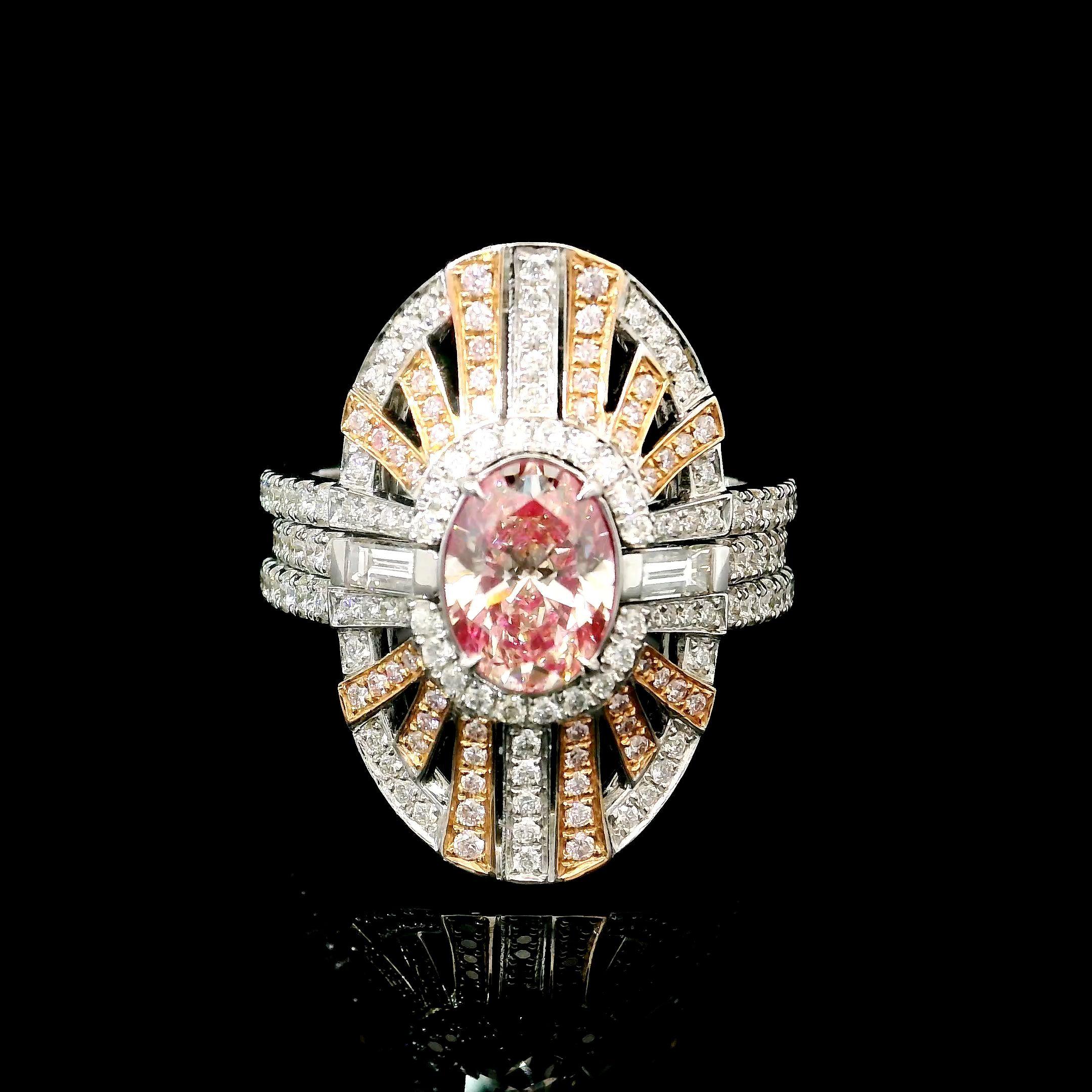 18kt white gold ring with diamonds
  
  Gold colour & karat: White gold 18kt
  Weight: 9.811 grams
  
  Set with-
  Stone type: Diamonds
  Shape: Oval
  Carat: 1.01 ct
  Colour: Fancy Pink
  Clarity: VS
  
  Surrounding Stones: Diamonds
 1) White