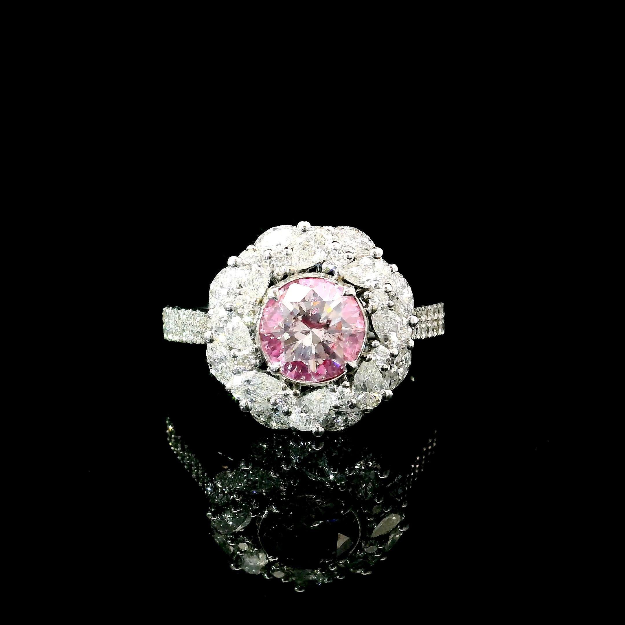 18kt white gold ring with diamonds
  
  Gold colour & karat: White gold 18kt
  Weight: 4.20 grams
  
  Set with-
  Stone type: Diamonds
  Shape: Round
  Carat: 1.01 ct
  Colour: Light Pink
  
  Surrounding Stones: Diamonds
 1) White Diamonds
  Carat