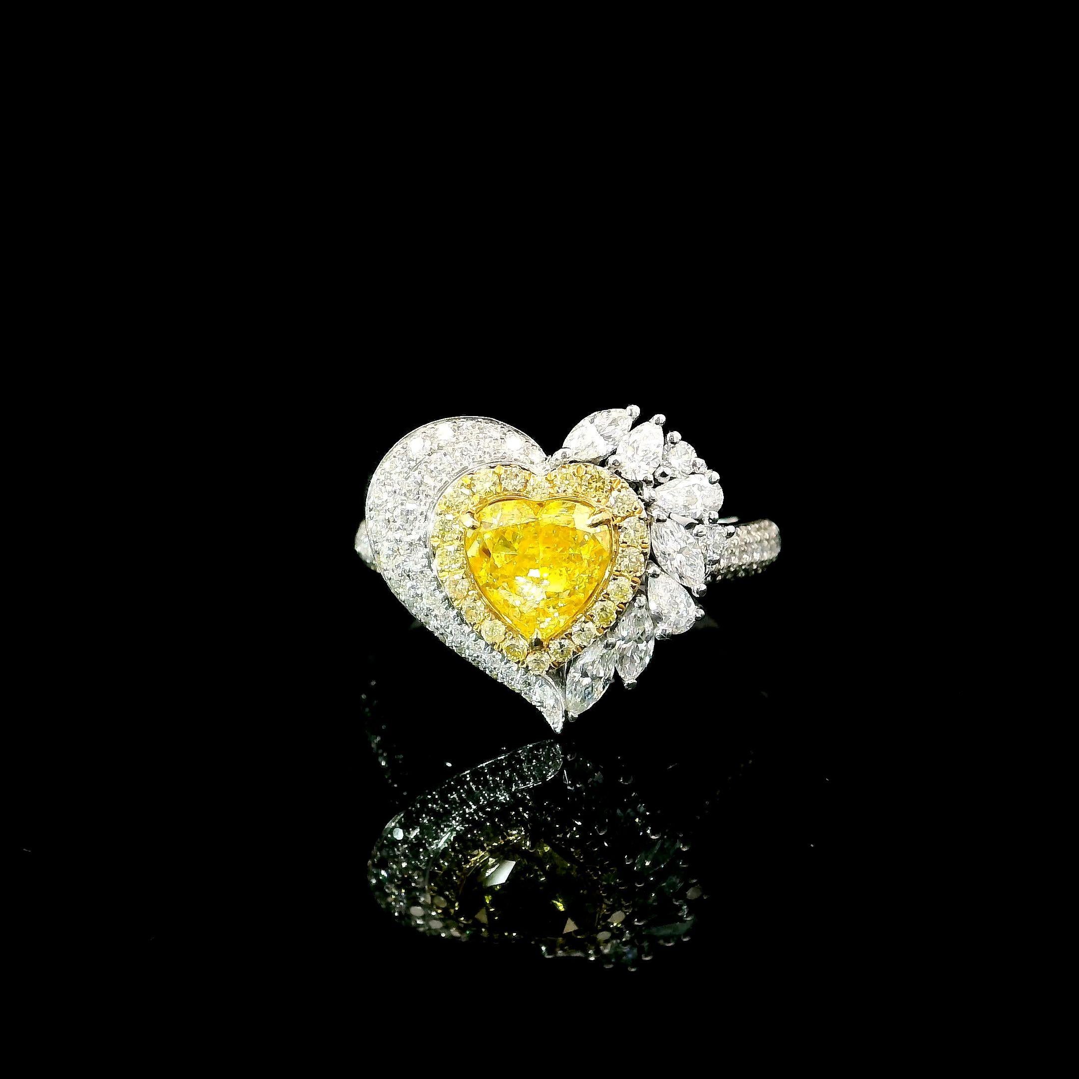 18kt white gold ring with diamonds
  
  Gold colour & karat: White gold 18kt
  Weight: 5.020 grams
  
  Set with-
  Stone type: Diamonds
  Shape: Heart
  Carat: 1.02 ct
  Colour: Fancy Yellow
  
  Surrounding Stones: Diamonds
 1) White Diamonds
 