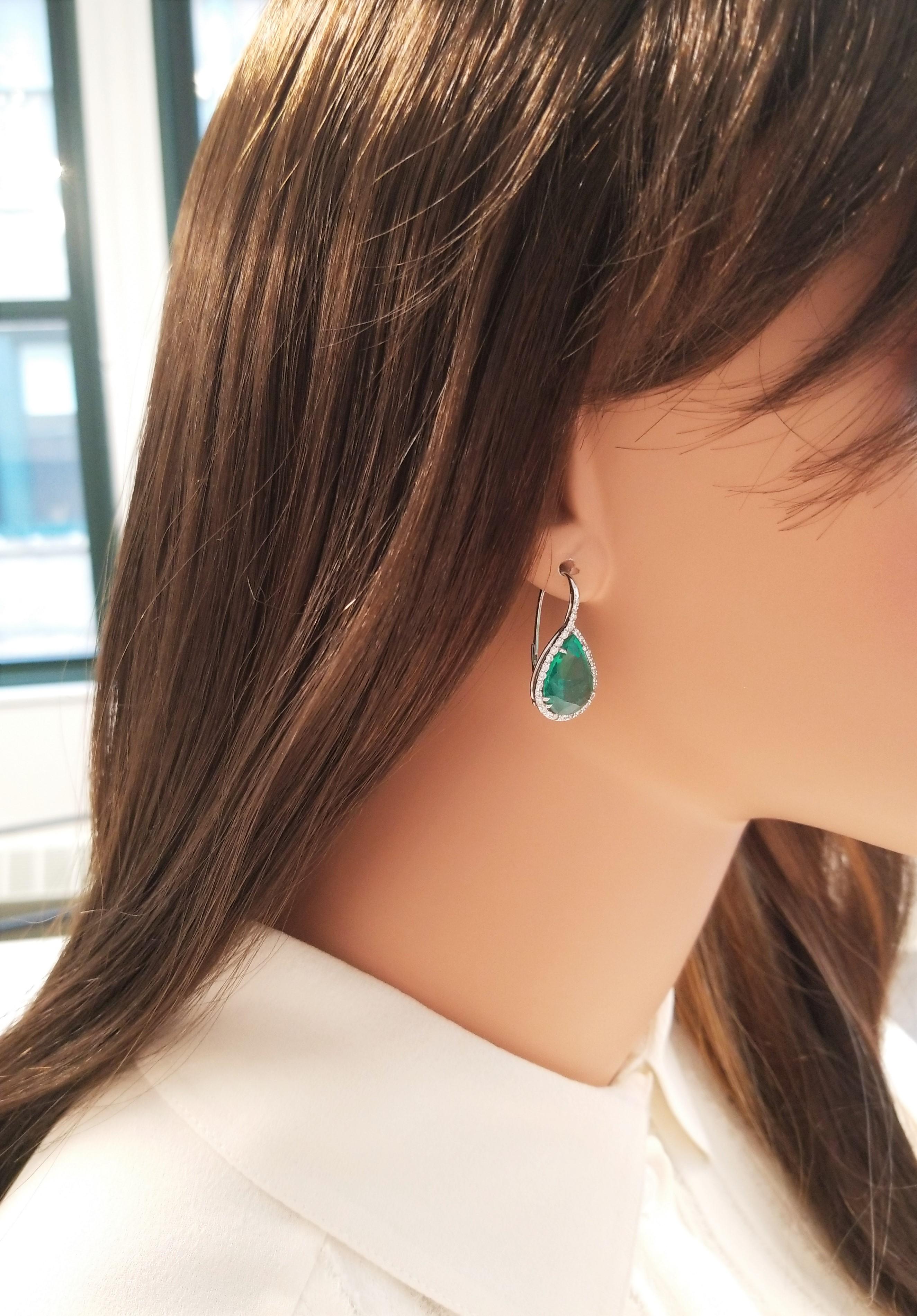 These forest-green emerald and diamond drop earrings will certainly get notice. The stunning emeralds are from Zambia. The pear shaped emeralds weigh 11.18 carat total weight and are encased in a brilliant halo of 0.76 carats of diamonds and 18k