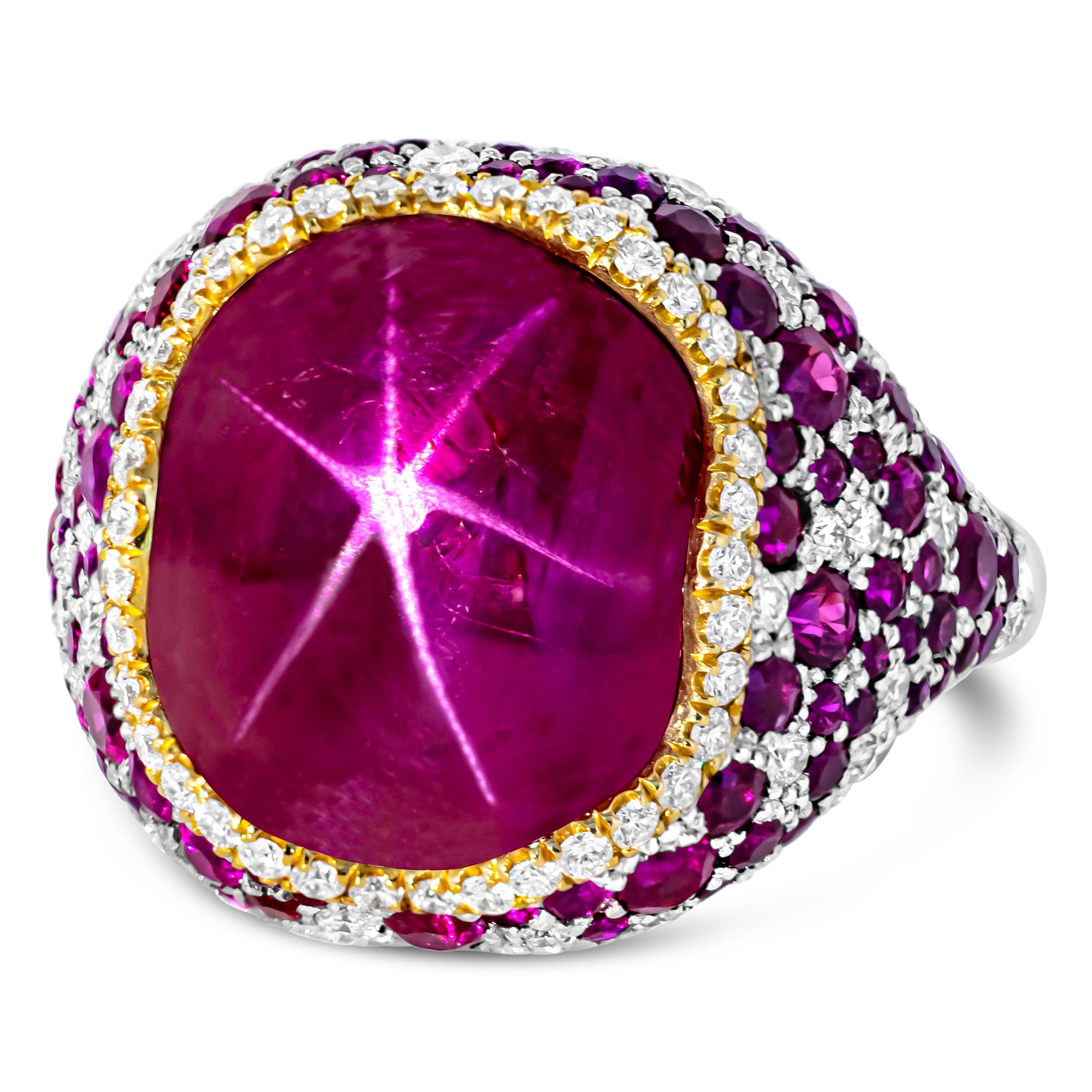 A fashionable and uniquely-designed cocktail ring showcasing a 11.28 carats cabochon star ruby certified by AGL as Burmese ruby with no indications of heat treatment. Accented with round melee rubies weighing 1.90 carats and round melee diamonds