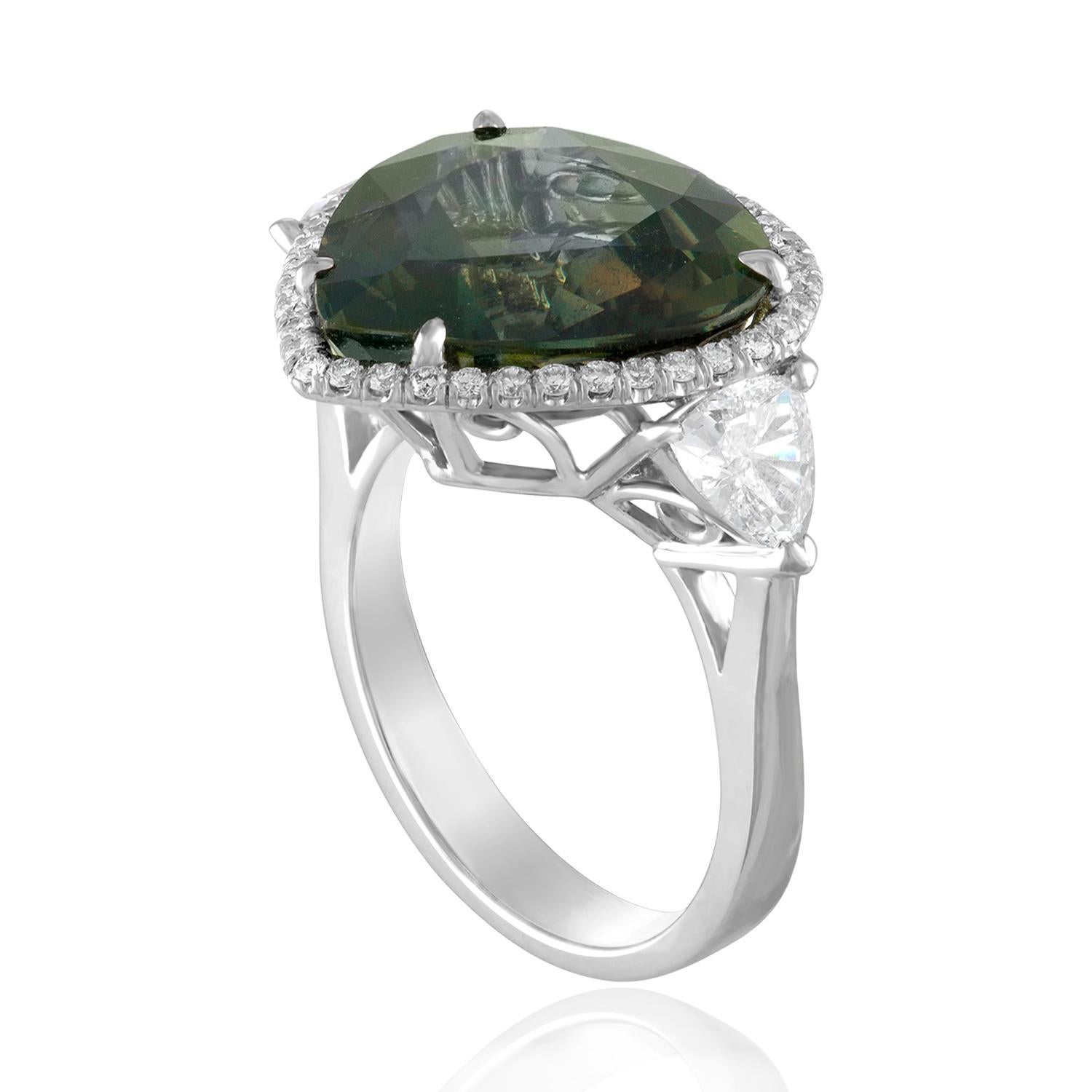 Beautiful 3 Stone Ring
The ring is 18K White Gold
The Center Stone is a Brownish Bluish Green Sapphire
The sapphire is Pear Shaped 11.61 Carat NO HEAT
The Sapphire is AGL Certified
The 2 side stones are Trillions 0.78 Carat E/F VS
There are 0.26