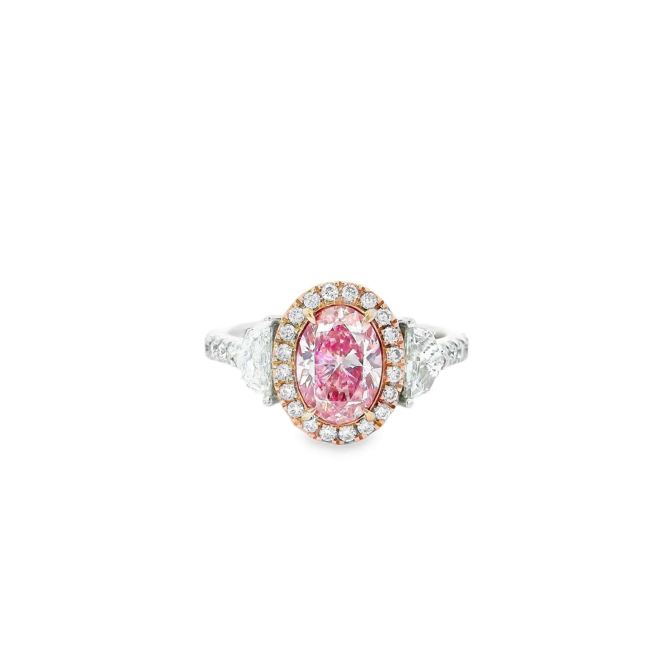 18kt white gold ring with diamonds
  
  Gold colour & karat: White gold 18kt
  Weight: 4.85 grams
  
  Set with-
  Stone type: Diamonds
  Shape: Oval
  Carat: 1.20 ct
  Colour: Fancy Pink
  Clarity: VS
  
  Surrounding Stones: Diamonds
 1) White