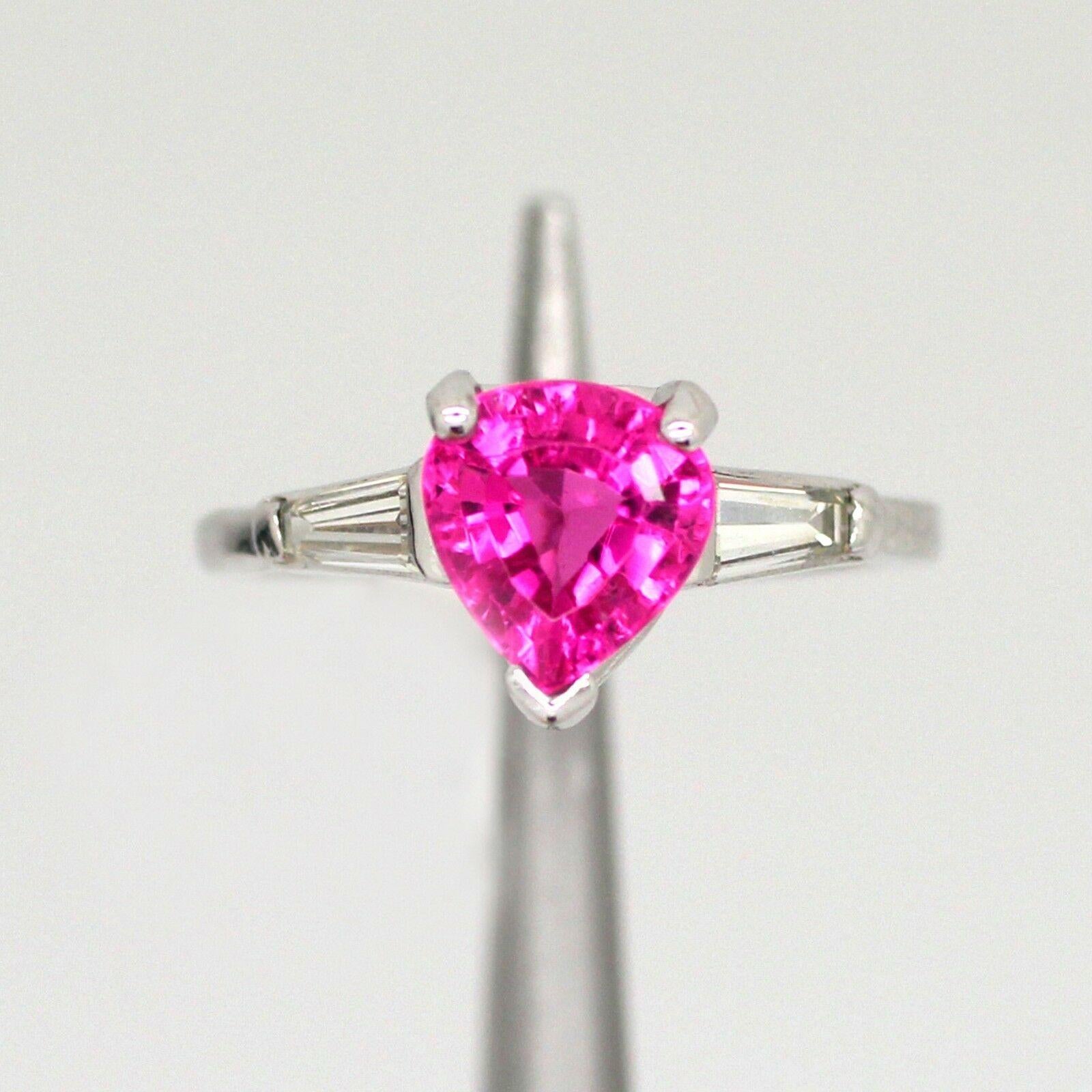           This platinum ring features an AGL certified 1.33 carat natural tourmaline, pink color, and pear mixed cut center gemstone. It contains a tapered baguette diamond on each side, G in color and VS2 in clarity, approximately weighing at 0.30
