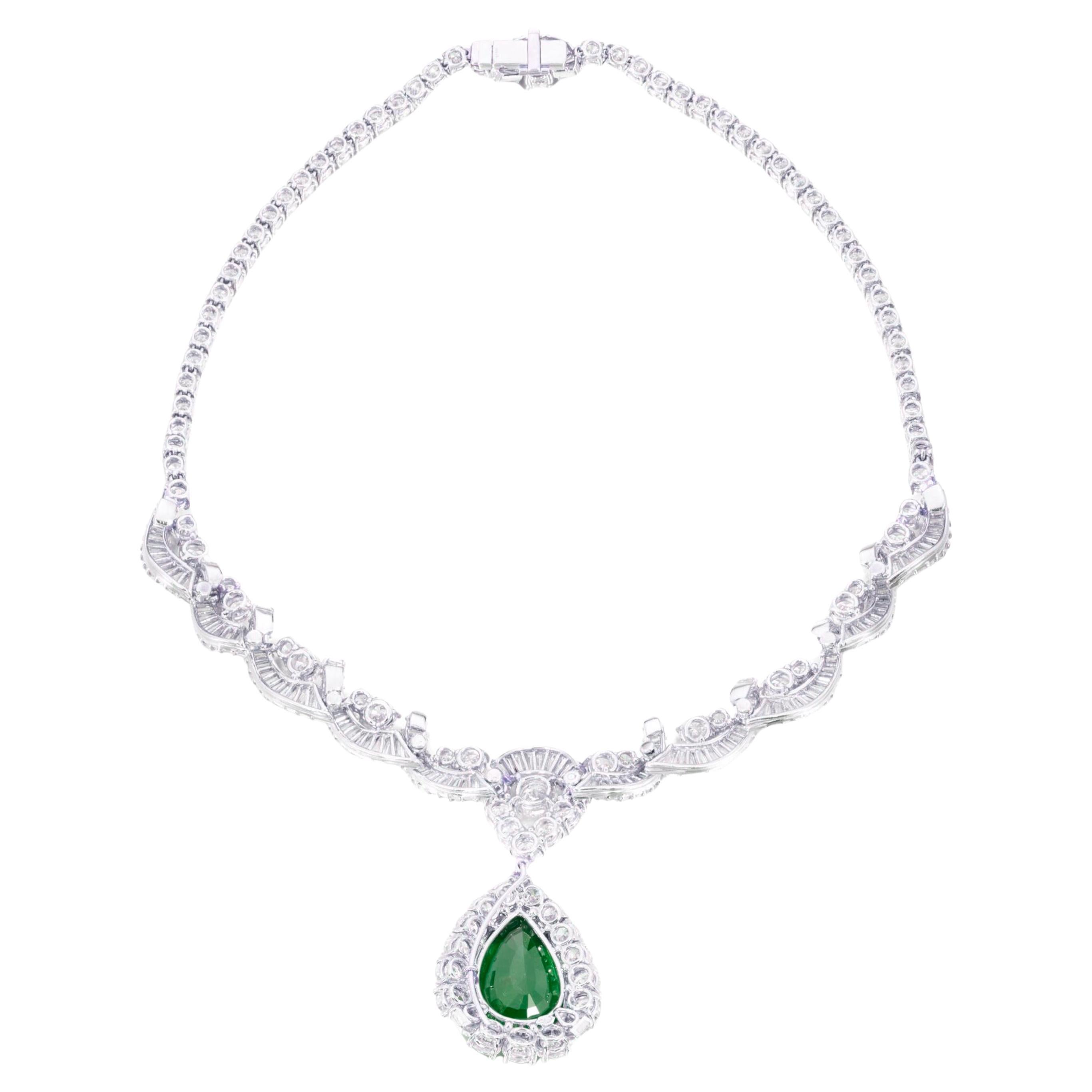 This stunning necklace showcases a sophisticated scroll design adorned with a mix of brilliant-cut, baguette, and tapered baguette diamonds. At its center, a detachable pendant features a magnificent 15-carat pear-shaped emerald ramed by sparkling