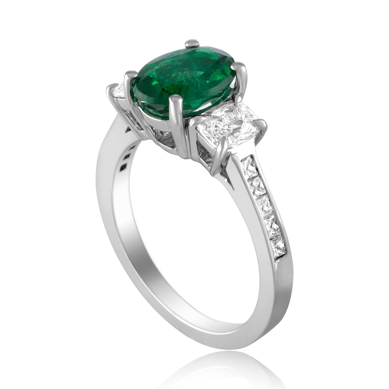 Beautiful Three Stone Emerald Ring
The ring is 18K White Gold.
There are 2 side stones 0.62 Carats Diamonds F VS
The Band has small princess cut diamonds 0.23 Carats F VS
The Center is a beautiful oval 1.55 Carat Emerald.
The Emerald is AGL