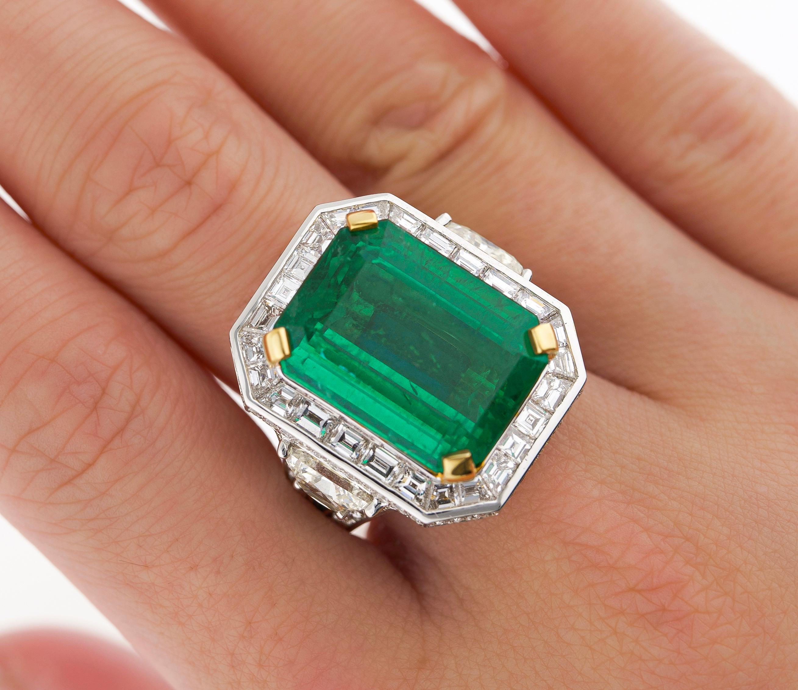 18 karat white gold emerald and diamond ring. Set with over 20 carats in natural emerald diamonds. 

The center stone emerald bears an incredible green color profile. A rich, vibrant green hue with excellent transparency and luster. A substantial
