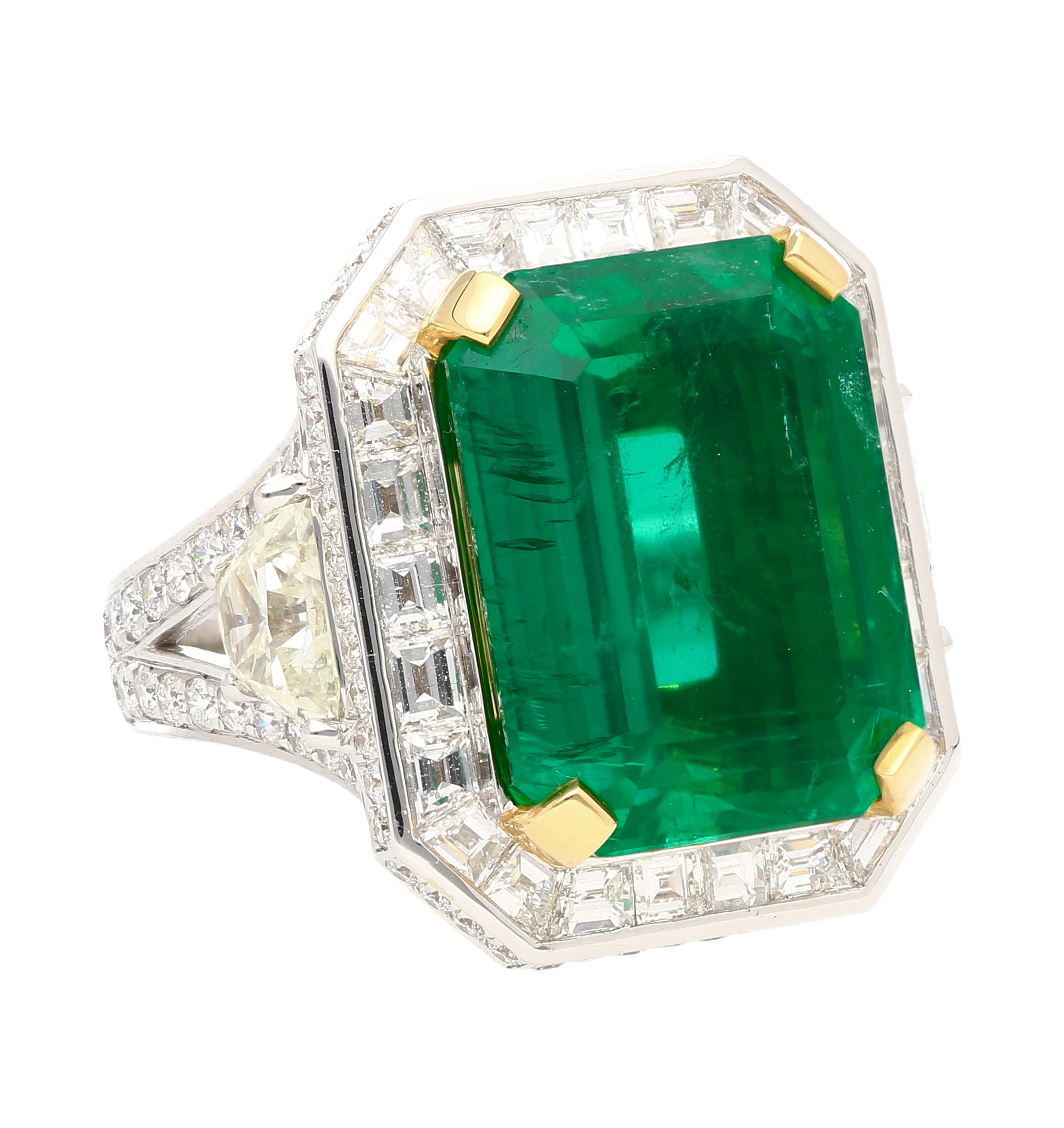 18 karat white gold emerald and diamond ring. Set with over 20 carats in natural emerald diamonds. 

The center stone emerald bears an incredible green color profile. A rich, vibrant green hue with excellent transparency and luster. A substantial