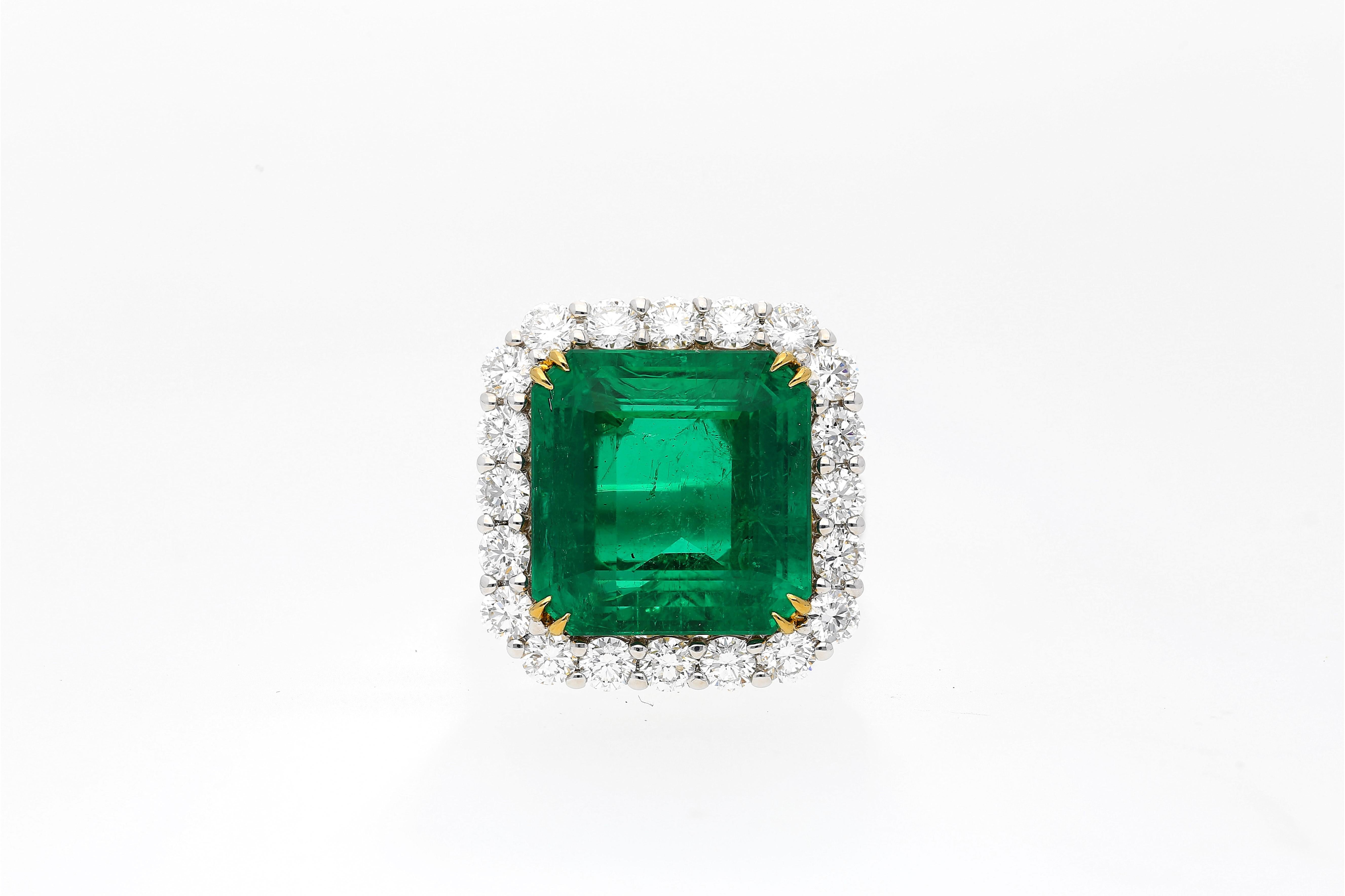 16.46 Carat Emerald-Cut vivid green Colombian Emerald framed by 48 Round-Brilliant Cut Diamonds totaling 2.60 Carats, and set in lush white and yellow 18 karat gold. This legendary center stone is of Colombian origin, and contains minor amounts of