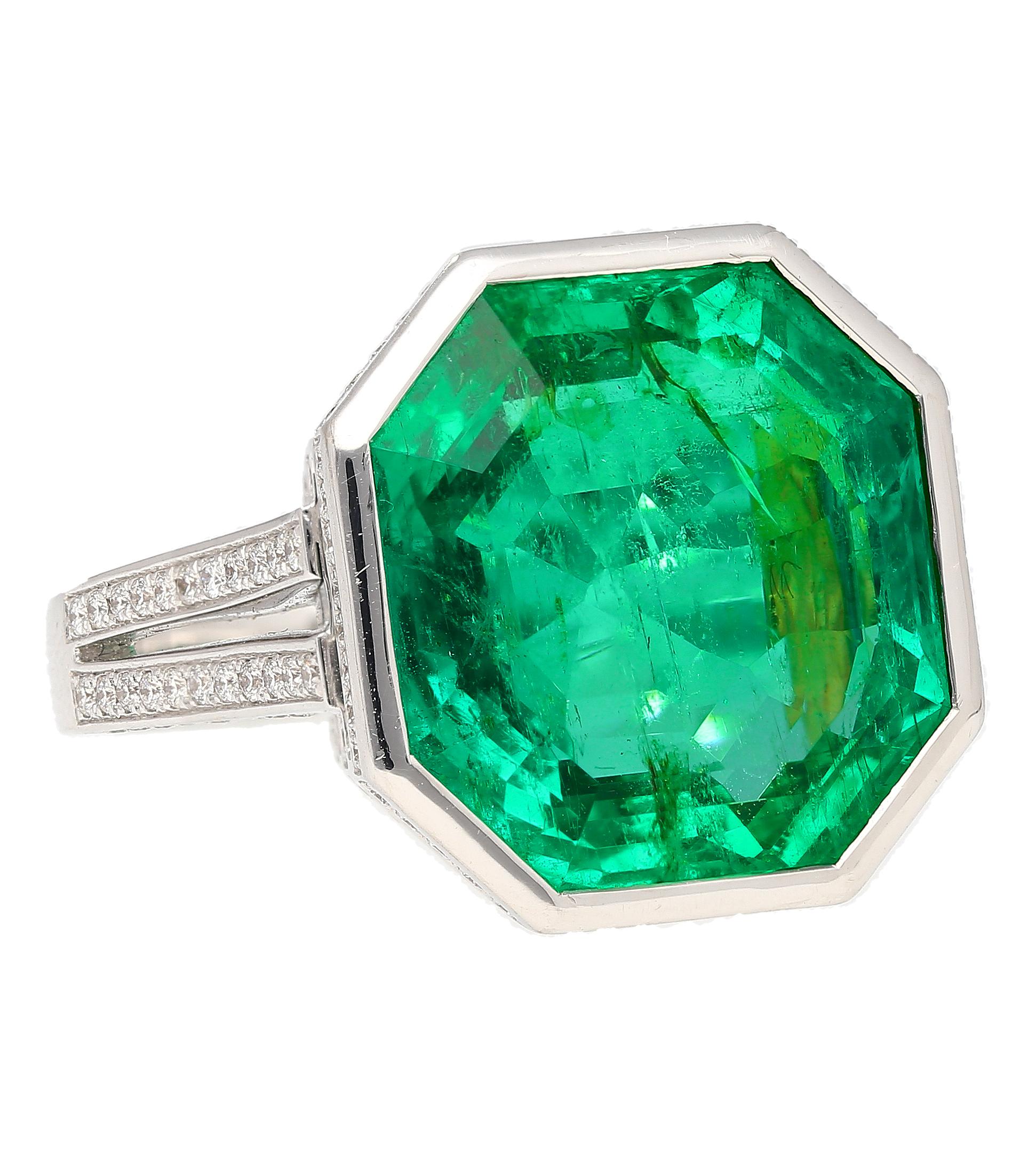Experience the pinnacle of sophistication with our 17 Carat Octagonal Cut Colombian Emerald. AGL Certified minor oil. Set in flawless 18k white gold and adorned with a stunning array of natural round-cut diamonds, this investment-grade piece is