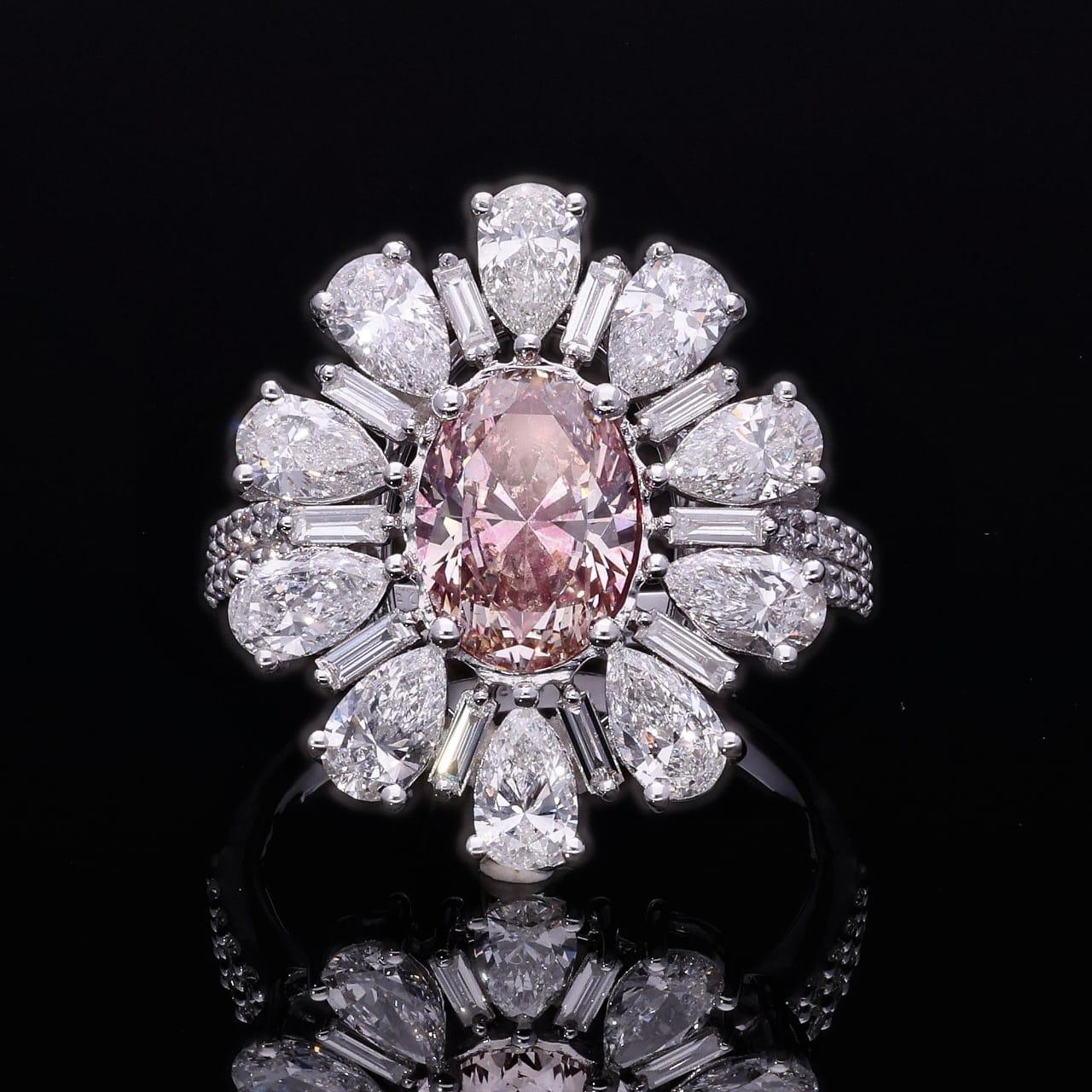 18kt white gold ring with diamonds
  
  Gold colour & karat: White gold 18kt
  Weight: 6.09 grams
  
  Set with-
  Stone type: Diamonds
  Shape: Oval
  Carat: 1.73 ct
  Colour: Fancy Pink
  Clarity: VS
  
  Surrounding Stones: Diamonds
 1) White