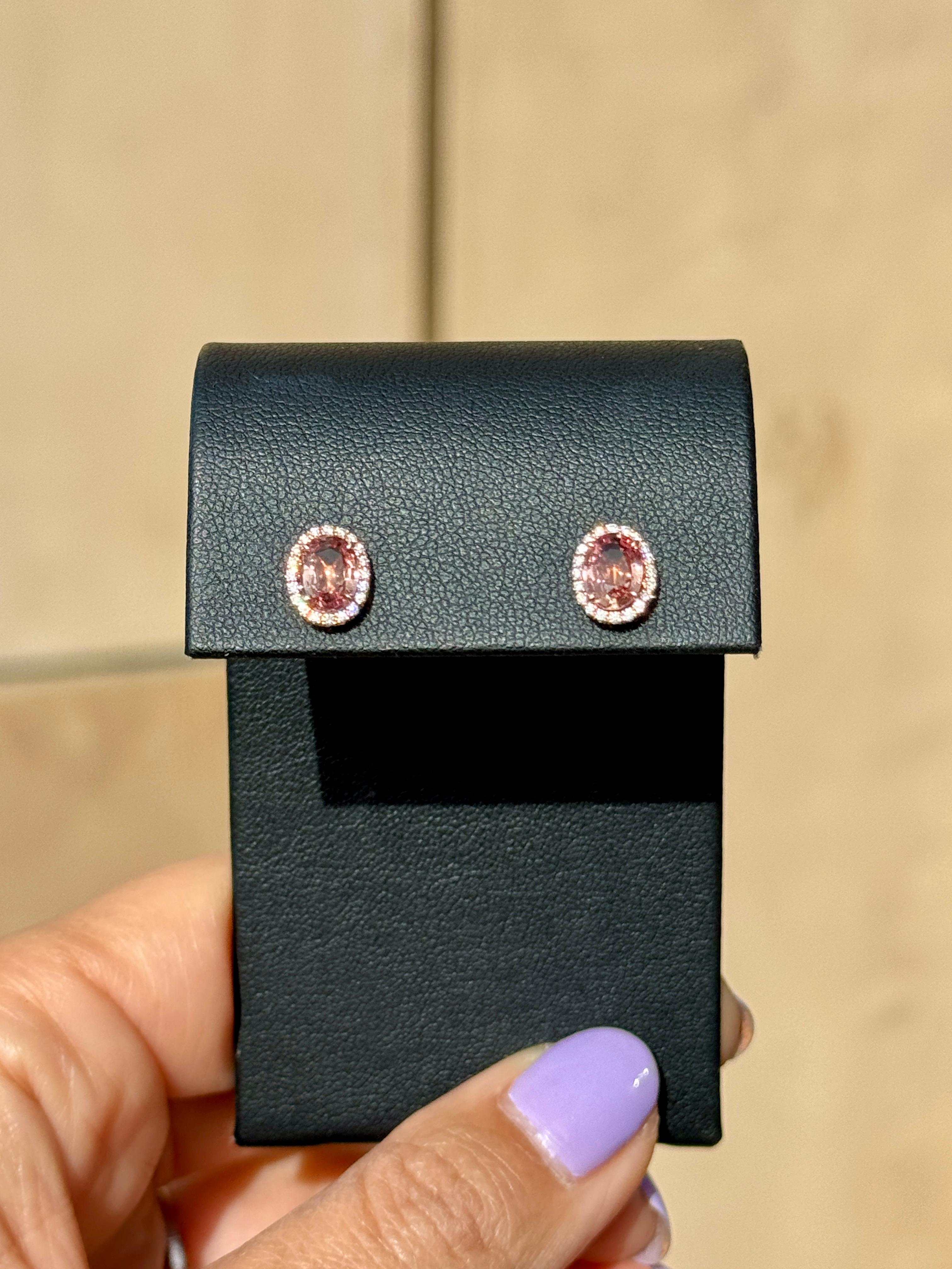 Certifies as Brown-Pinkish Orange resembling Padparadscha Sapphire with 0.17ct G/VS diamonds set in 18k rose gold mountings with 14k rose gold backs.