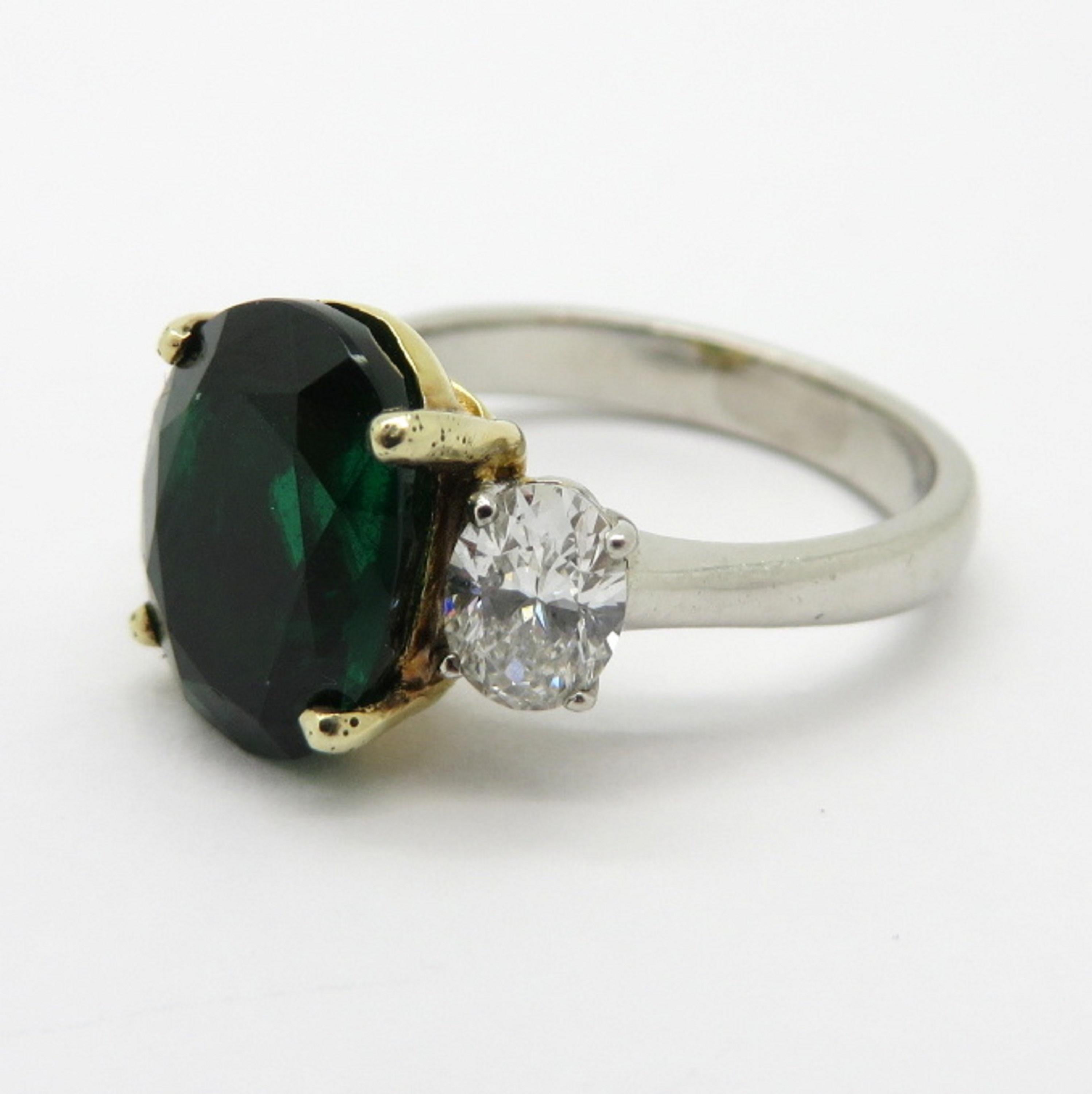 For sale is a gorgeous three stone ring that can symbolize your Past, Present, and Future together.
Crafted out of 18K Solid Yellow Gold and Platinum.
The Emerald in the center is four prong set, and includes an AGL- American Gemological Laboratory