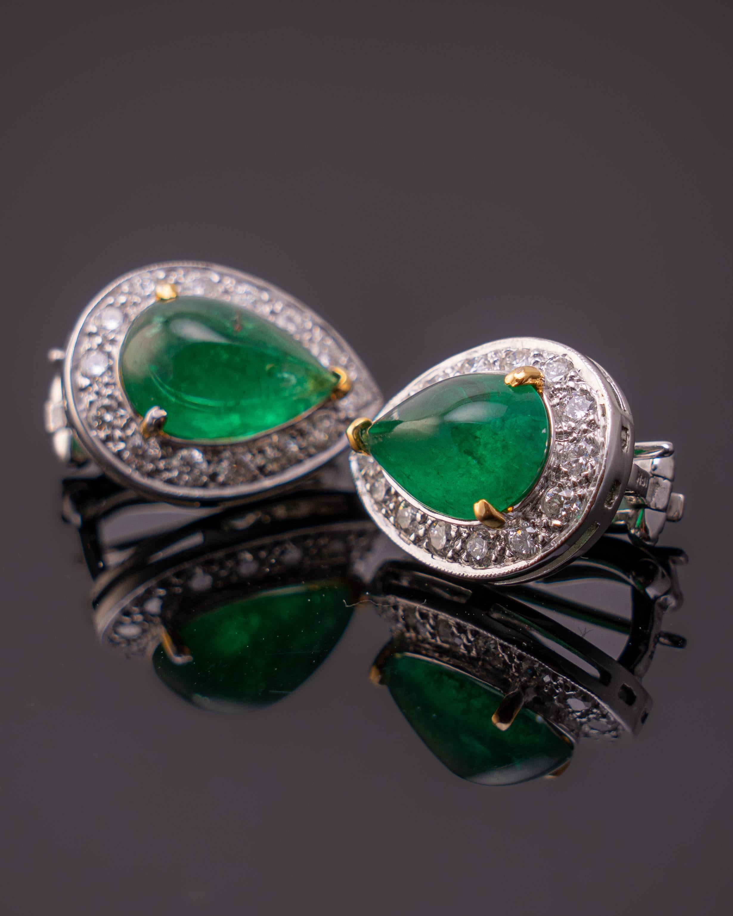 A pair of Zambian 12.98 carat cabochon emerald earrings set in 18K white gold with diamond details . The green hue makes the earrings have a Colombian tinch. A rare piece in indeed set with 0.37 of diamonds .

Free Shipping Worldwide and Returns