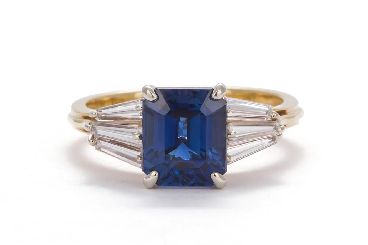 We are pleased to offer this AGL Certified 18k Yellow & White Gold Sapphire & Diamond Ring. This stunning ring feature a 3.77ct emerald cut natural sapphire from Thailand accented by approximately 0.55ctw baguette cut diamonds all set in a 18k