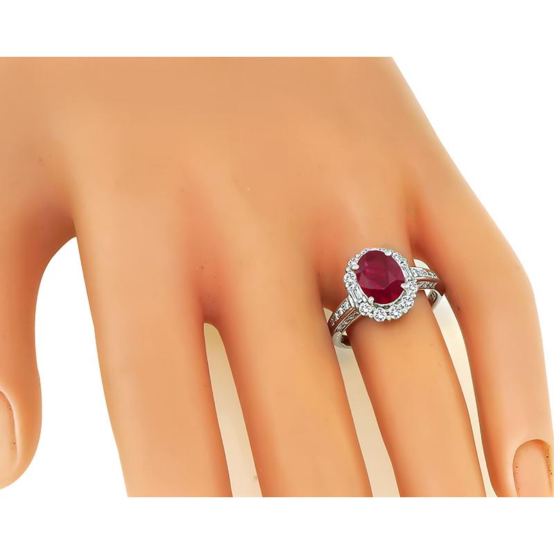 This is a stunning platinum engagement ring. The ring is centered with a lovely AGL certified Burmese ruby that weighs 2.03ct. The ruby is accentuated by sparkling round and baguette cut diamonds that weigh approximately 0.67ct. The color of these