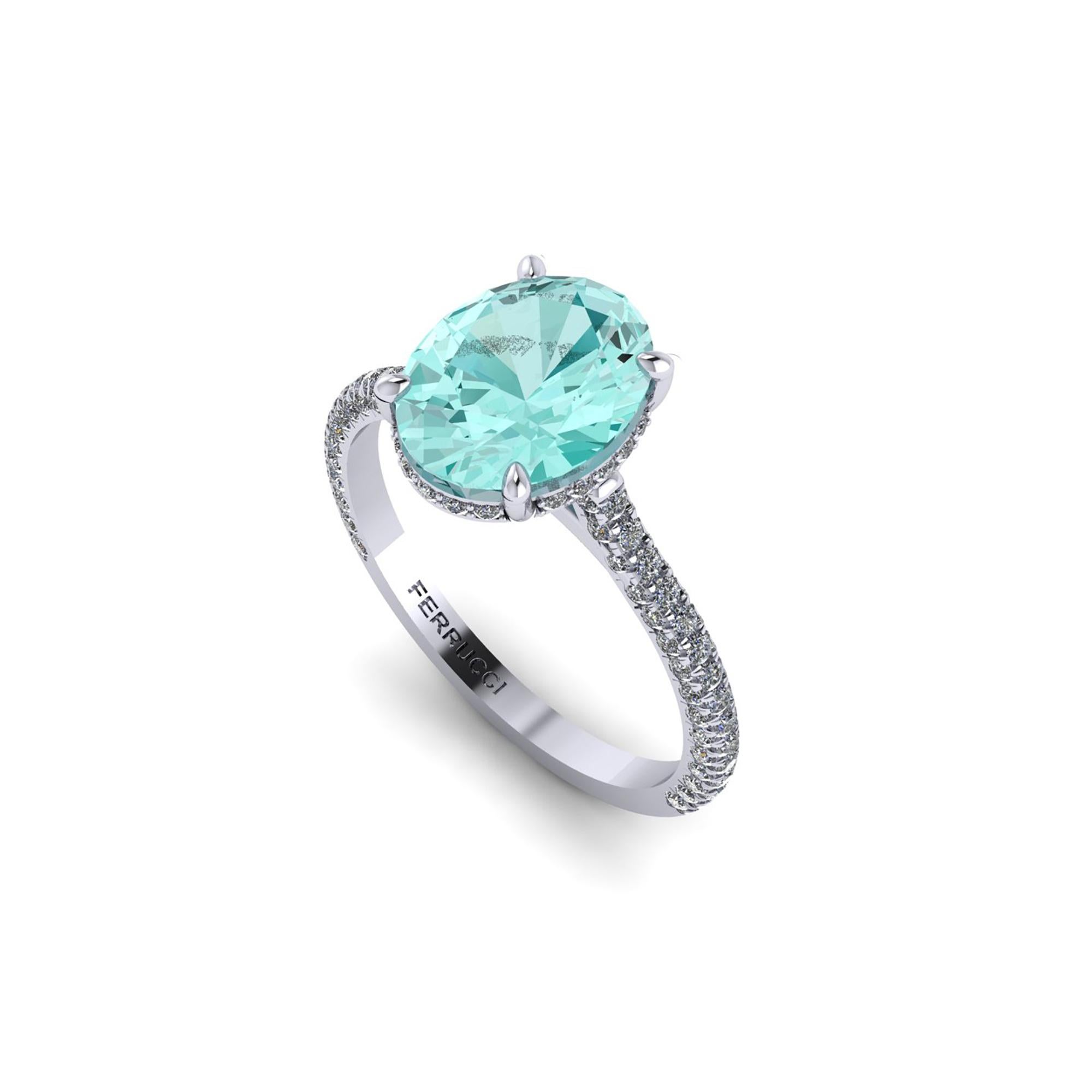 AGL Certified 2.11 carat Paraiba tourmaline, hand cut in Oval cut shape, a rare gem, conveiced in an hand made Platinum ring,
adorned with a shower of ultra white diamonds, hand set on almost every surface to give the maximum light reflection and