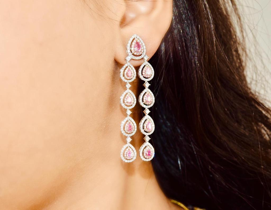 18kt white gold earring with diamonds
  
  Gold colour & karat: White gold 18kt
  Weight: 14.317 grams
  
  Set with-
  Stone type: Diamonds
  Shape: Pear
  Carat: 2.21
  Colour: Fancy Pink
  Clarity: SI 

  Surrounding Stones: Diamonds
 1) White