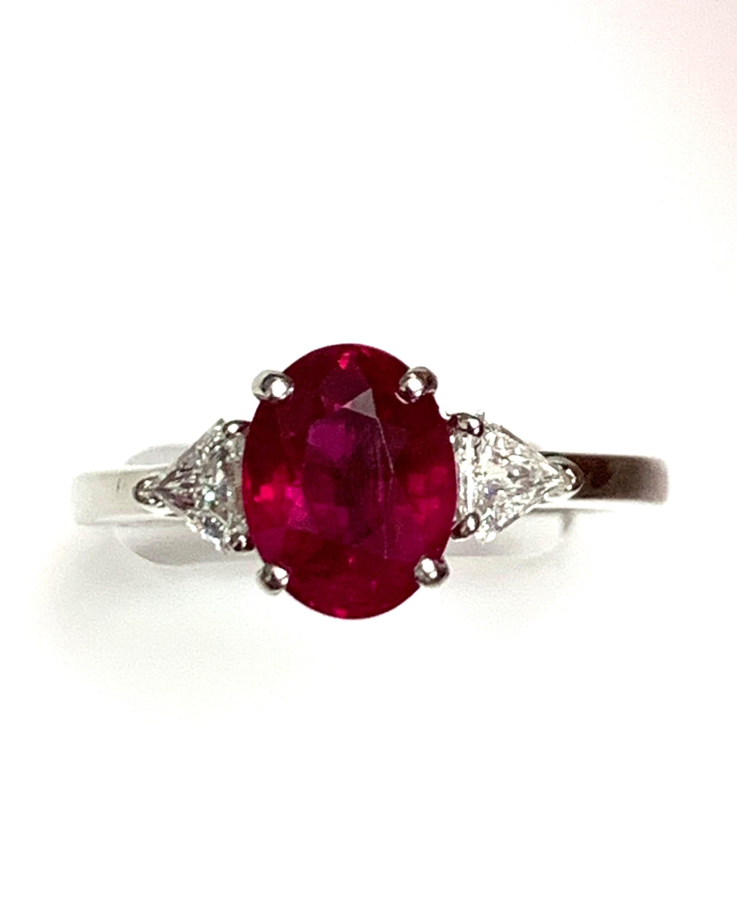 2.34 Carat oval Burma Ruby set in platinum hand made three stone ring with 0.34 carat shield cut G-h clean diamonds 