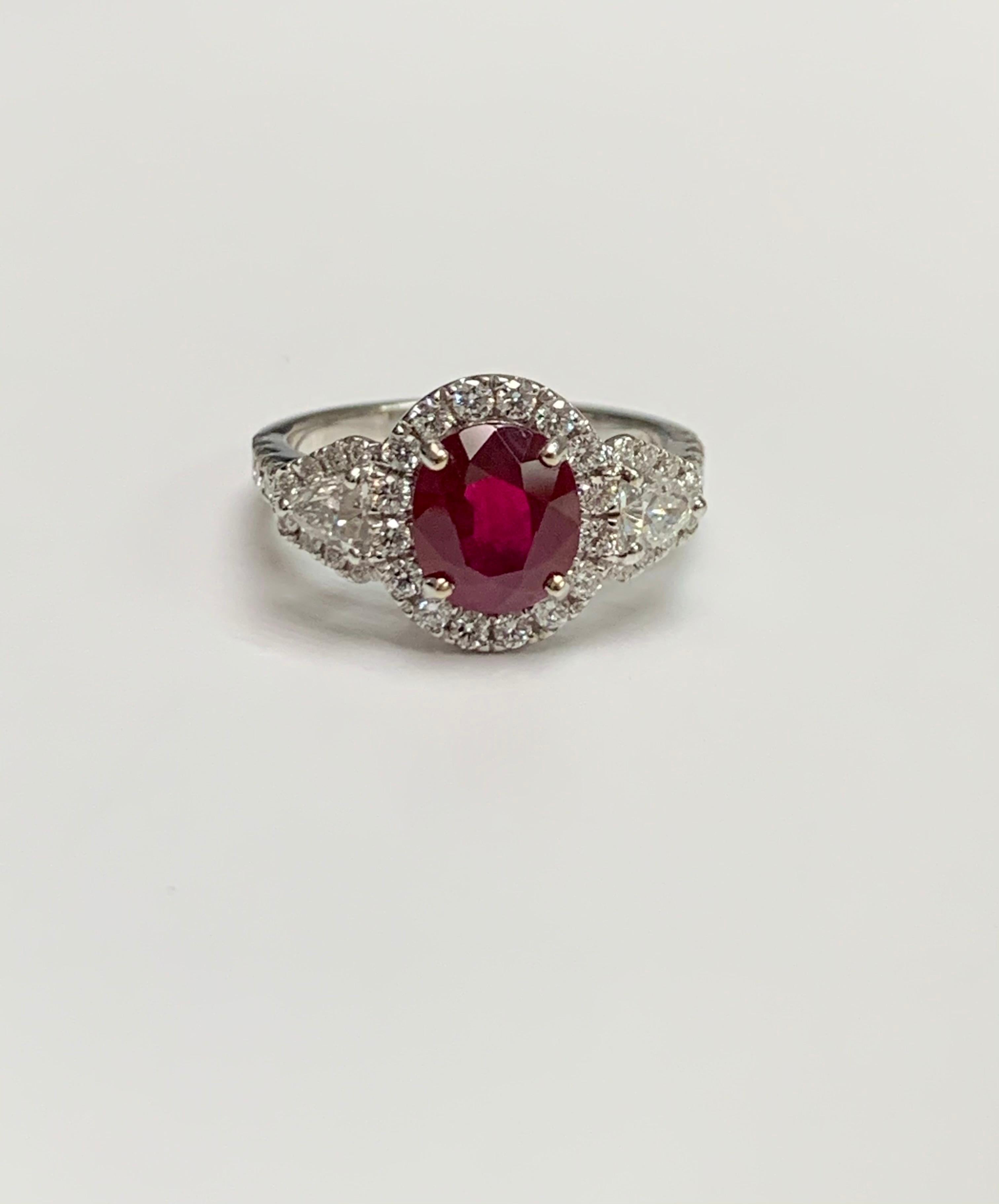 2.36 Carat oval cut Burma Ruby set in 18k white gold ring surrounded with 0.69 ct diamonds around it, shield cut diamonds on the shoulder and diamonds half way on the shank .