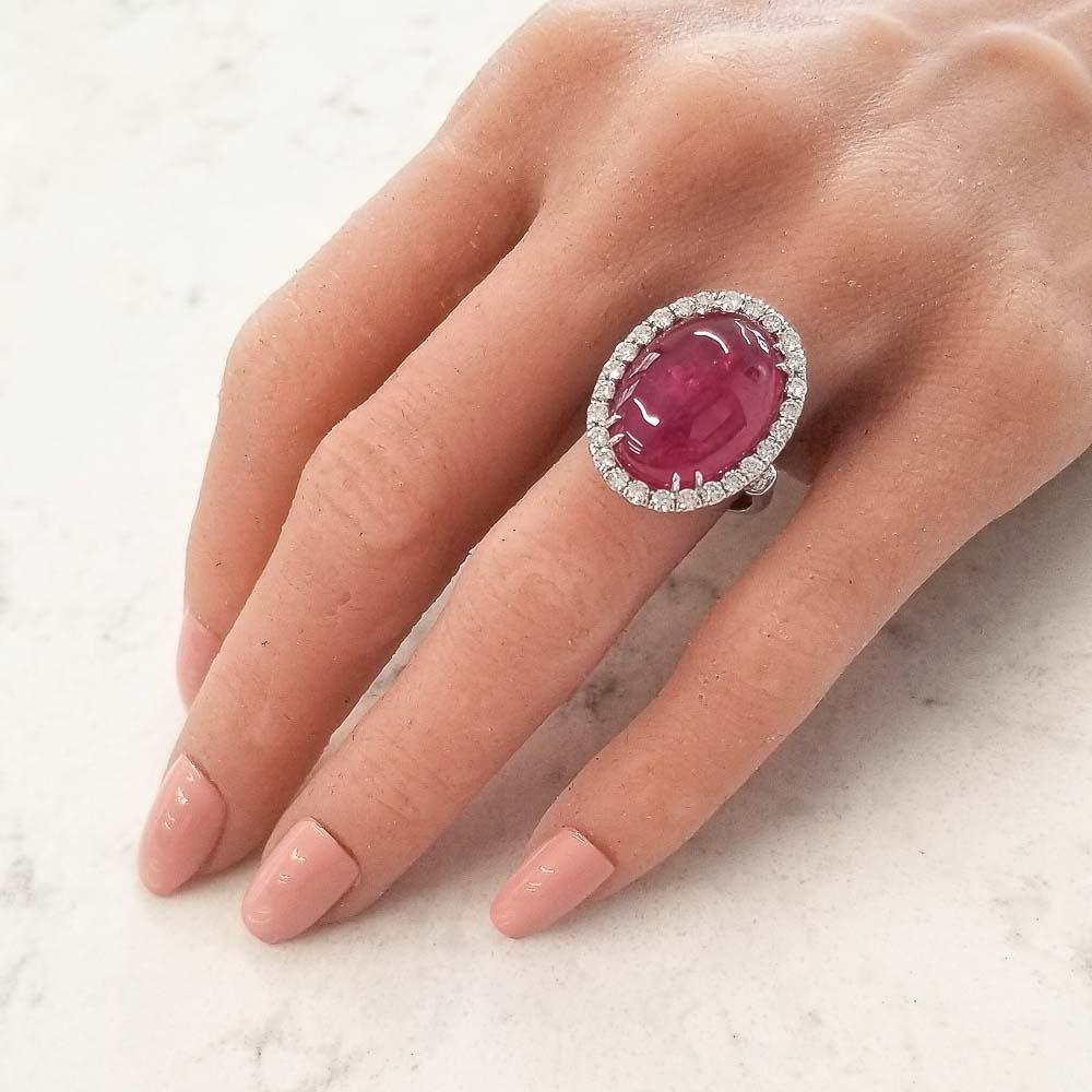 An attractively deep red ruby is the heartbeat of this stunning ring. This cabochon ruby is an incredible 24.25 carat – 19.02 x 14.05 millimeter. This gem was sourced from Thailand. Its color is vivid purplish red. The color distribution is evenly