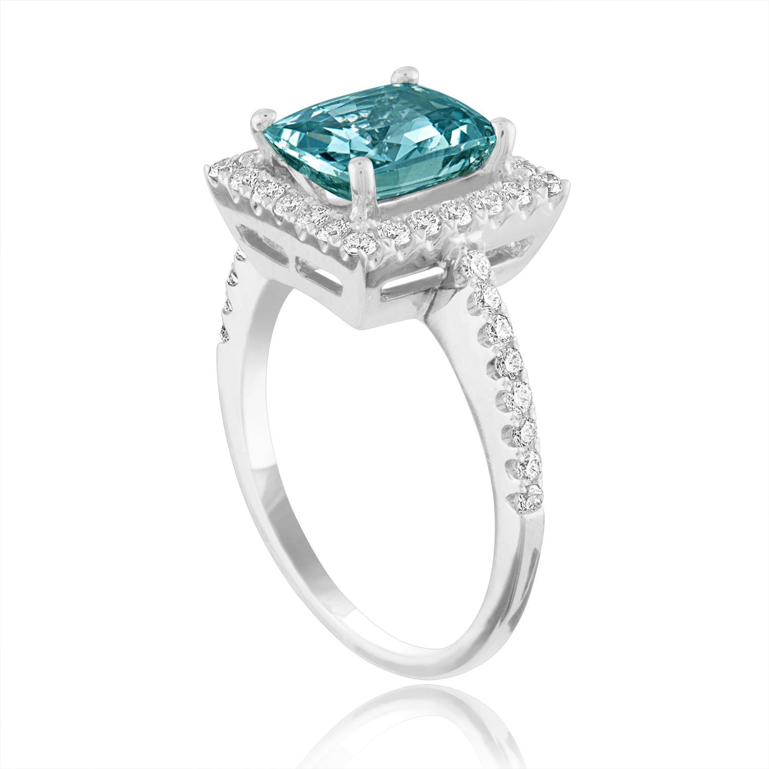 Beautiful Cushion Cut Halo Ring
The ring is 18K White Gold
The Center Stone is a Cushion Cut Grayish Green-Blue Sapphire 2.52 Carats
The Sapphire is AGL Certified Heated
There are 0.45 Carats in Diamonds F/G VS/SI
The ring is a size 6.50,