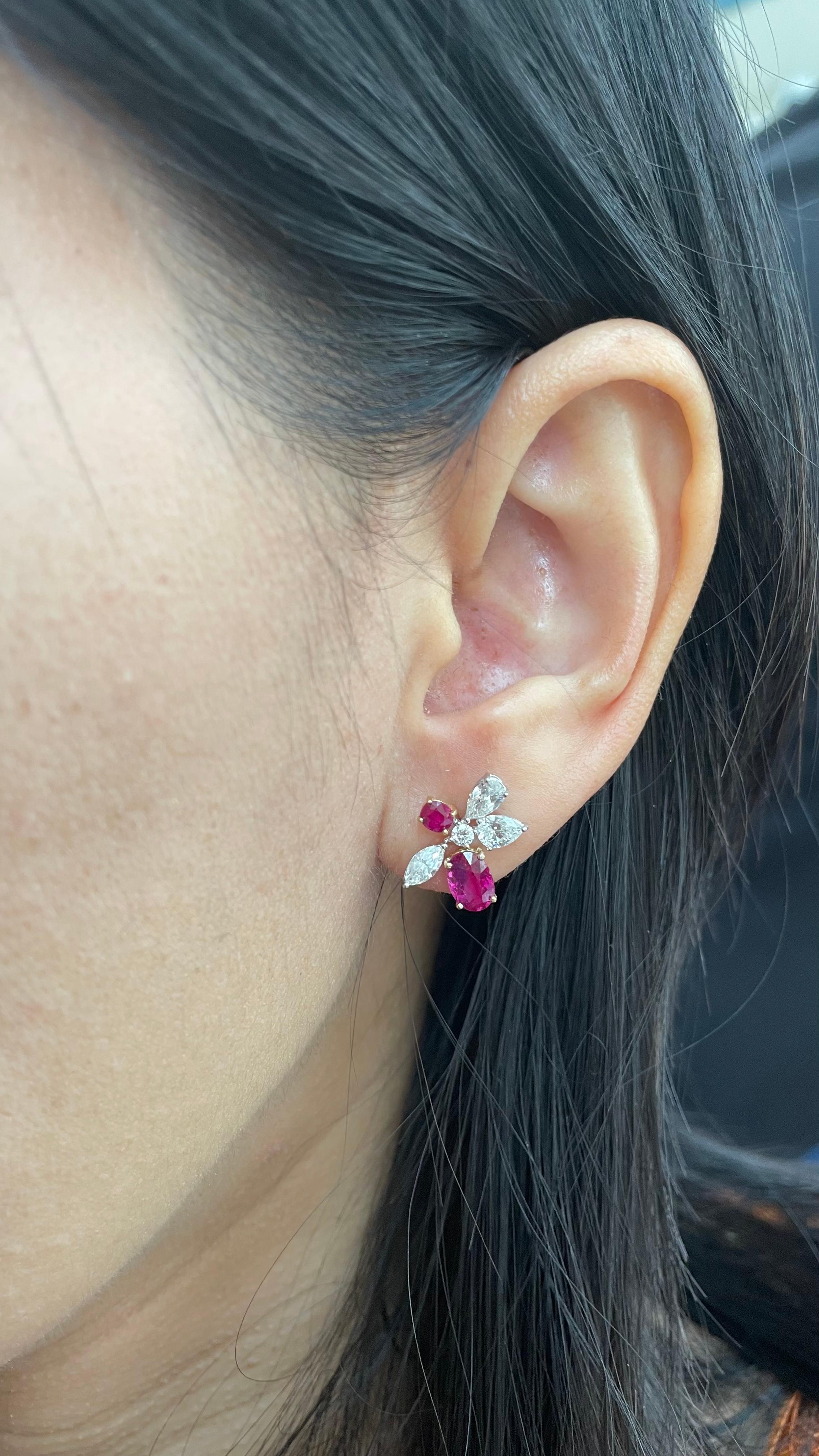 A pair of fine timeless ruby and diamond earrings made in 18 Karat gold. This pair of earrings embraces minimalism with its simple design while still displaying elegance; a great fit for lifestyle wear.

- There are two center oval Pigeon Blood