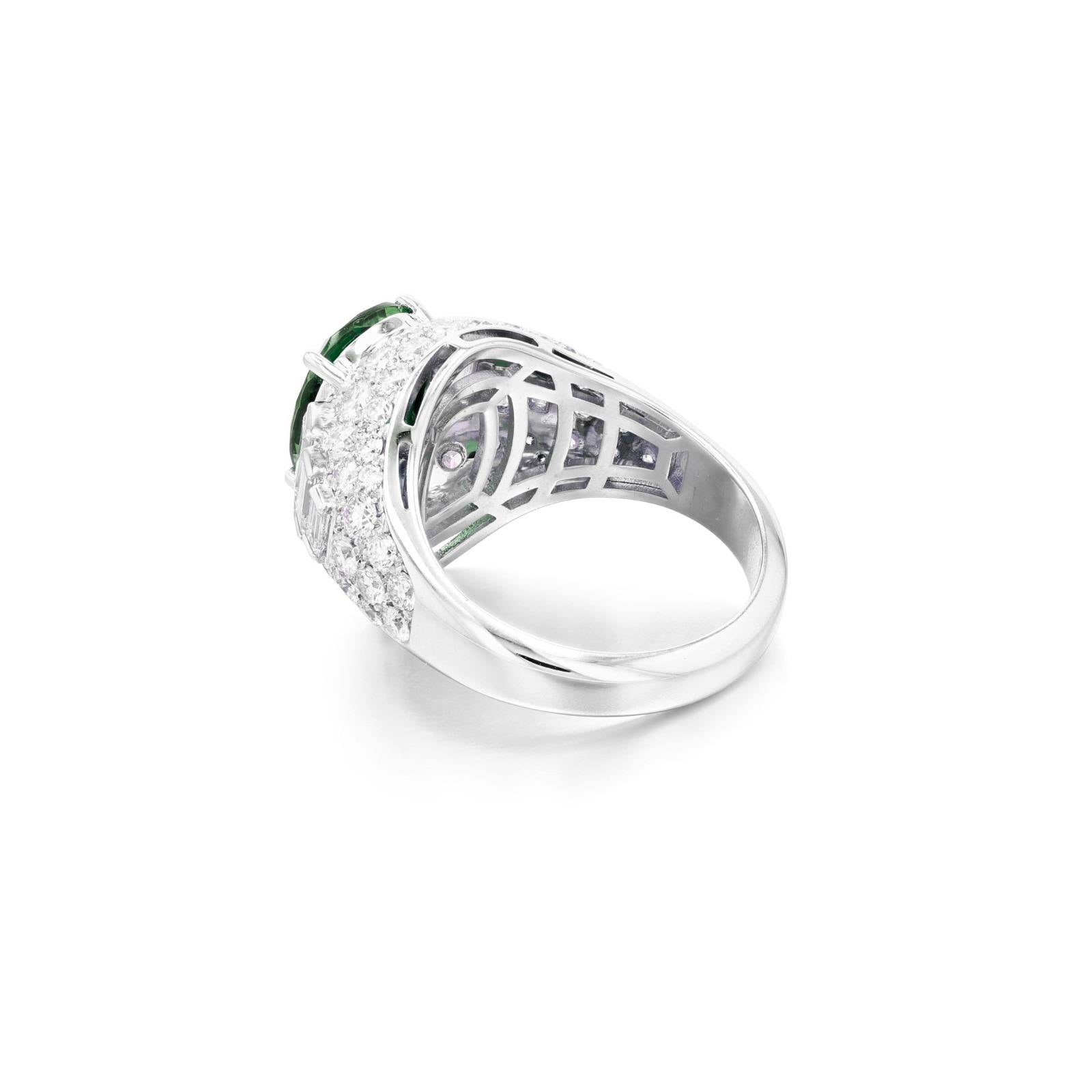 an exquisite ring featuring a captivating bombé design, elegantly adorned with a cushion emerald weighing 3 carats. This stunning piece is complemented by baguette diamonds that accentuate the beauty of the emerald, while the band is partially